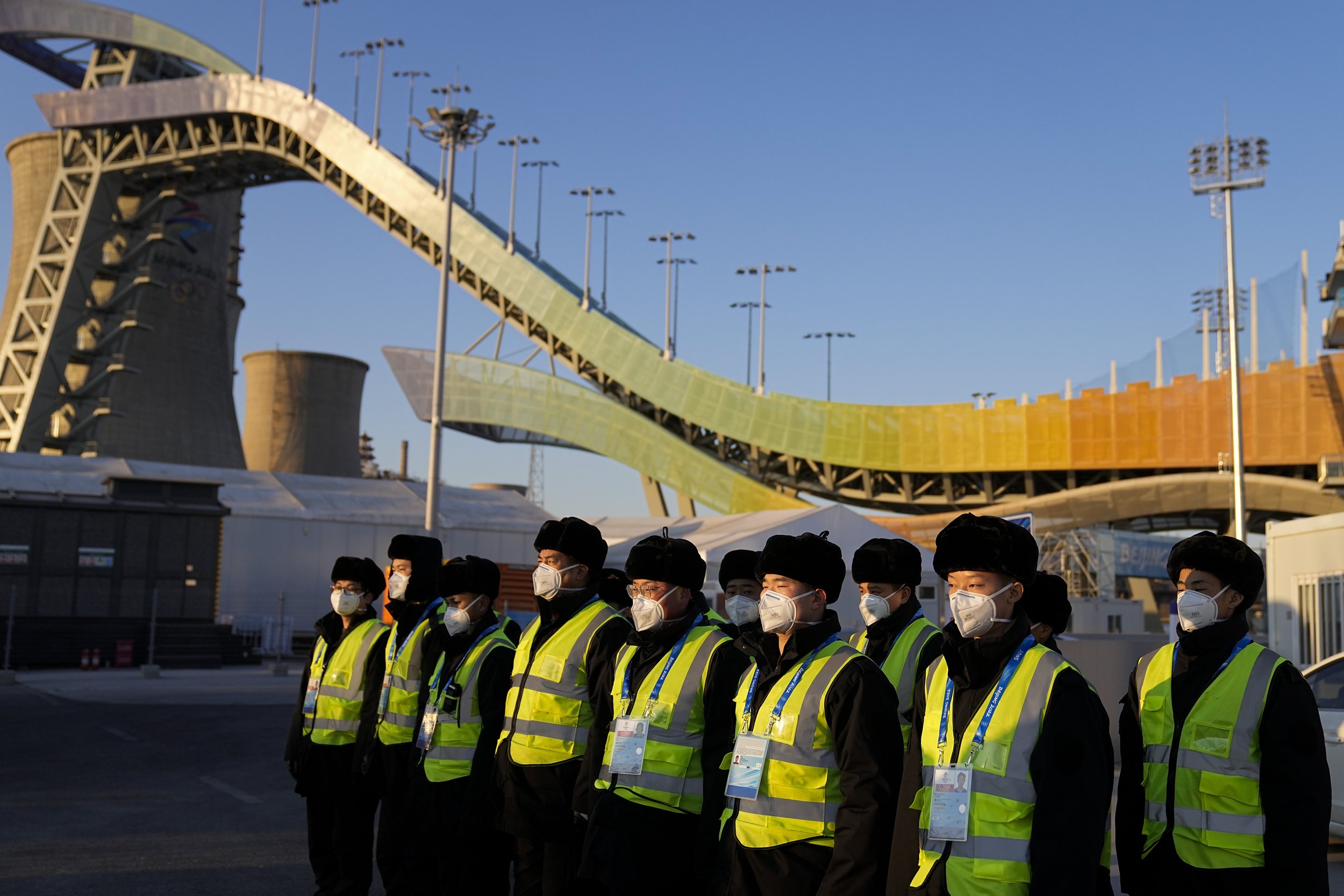  Security personnel gather in the parking lot of the Big Air Shougang ahead of the 2022 Winter Olympics, Tuesday, Feb. 1, 2022, in Beijing. (AP Photo/Jae C. Hong) 