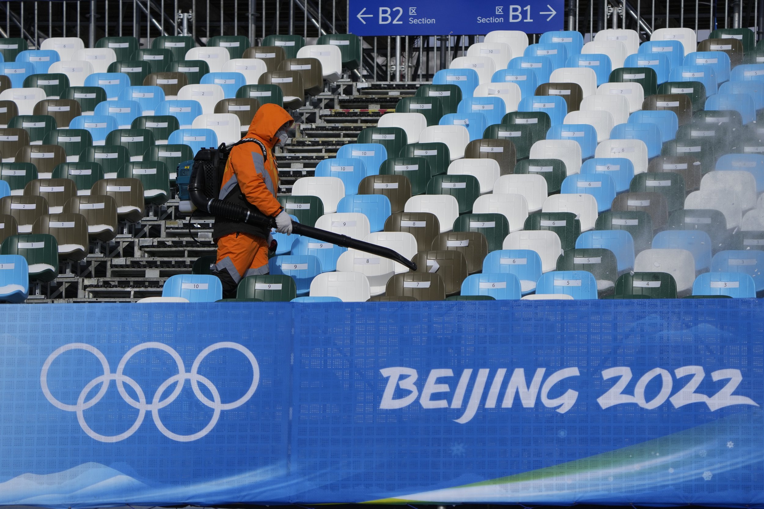 A worker blows off the snow in the seating area at Genting Snow Park prior to the 2022 Winter Olympics, Jan. 31, 2022, in Zhangjiakou, China. (AP Photo/Lee Jin-man) 