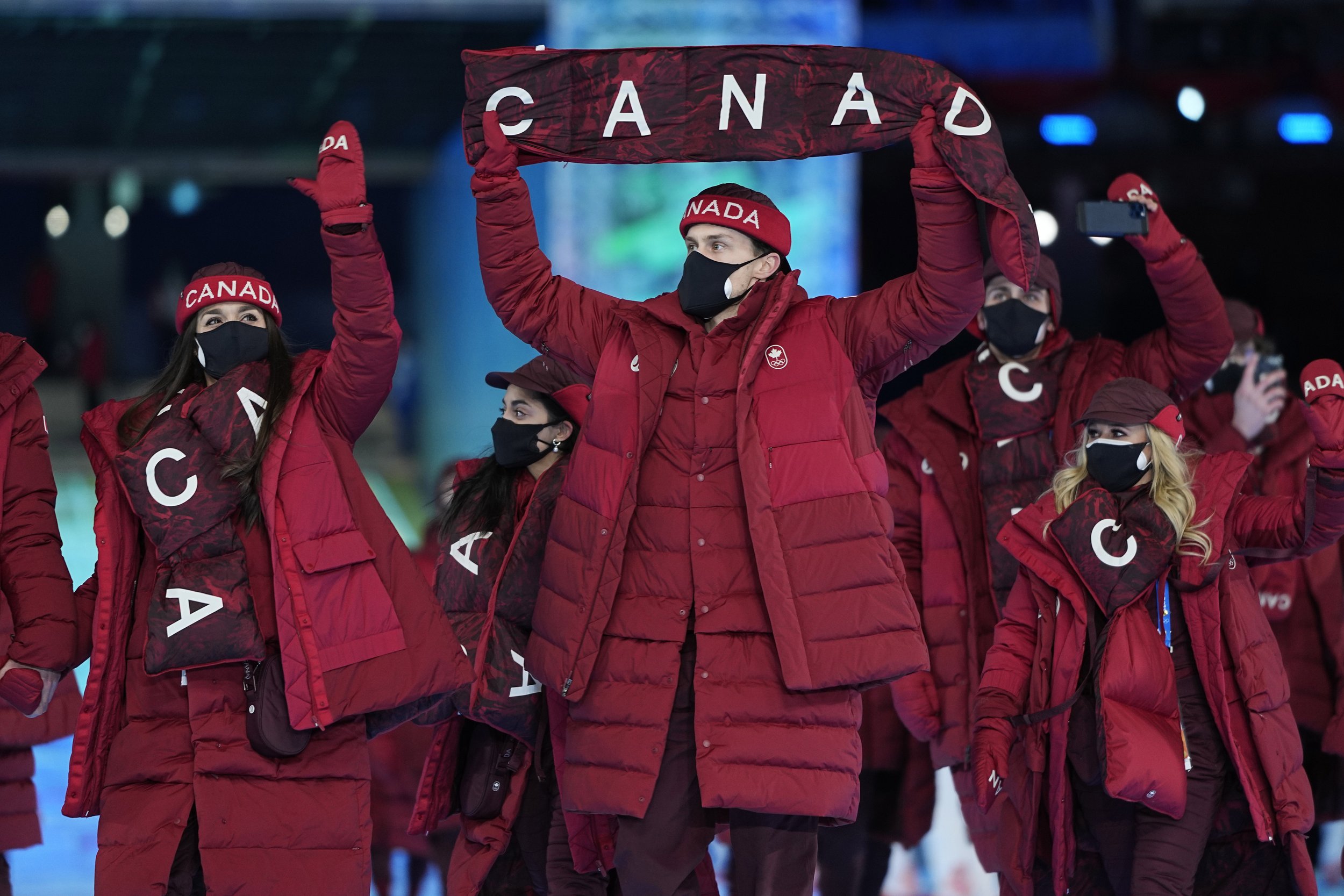  Athletes from Canada walk into the stadium during the opening ceremony of the 2022 Winter Olympics, Friday, Feb. 4, 2022, in Beijing. (AP Photo/Jae C. Hong) 