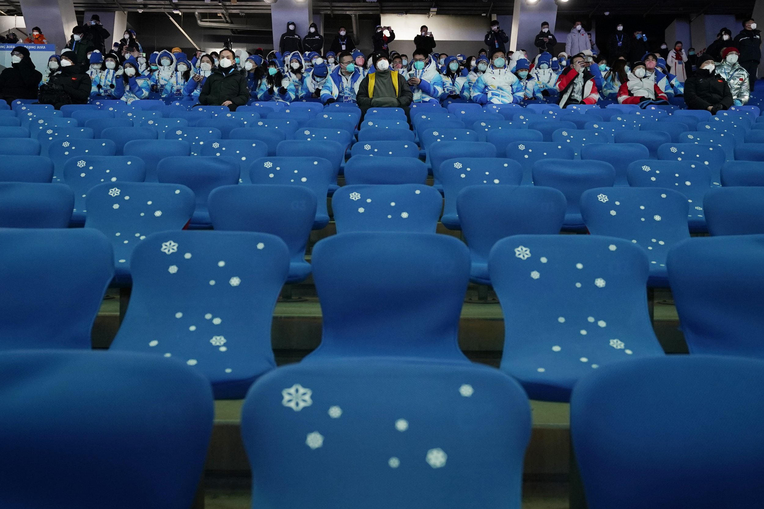  Spectators watch the pre-show ahead of the opening ceremony of the 2022 Winter Olympics, Friday, Feb. 4, 2022, in Beijing. (AP Photo/Jae C. Hong) 