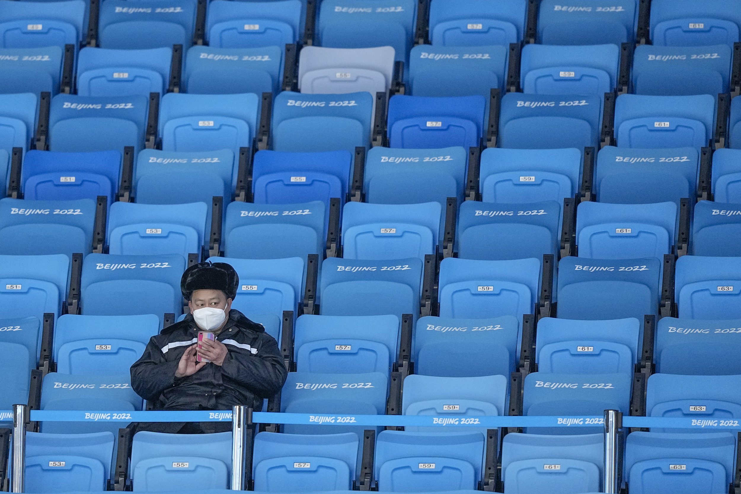  A lone fan waits for the start of the men's singles short program in the figure skating competition at the 2022 Winter Olympics, Friday, Feb. 4, 2022, in Beijing. (AP Photo/David J. Phillip) 