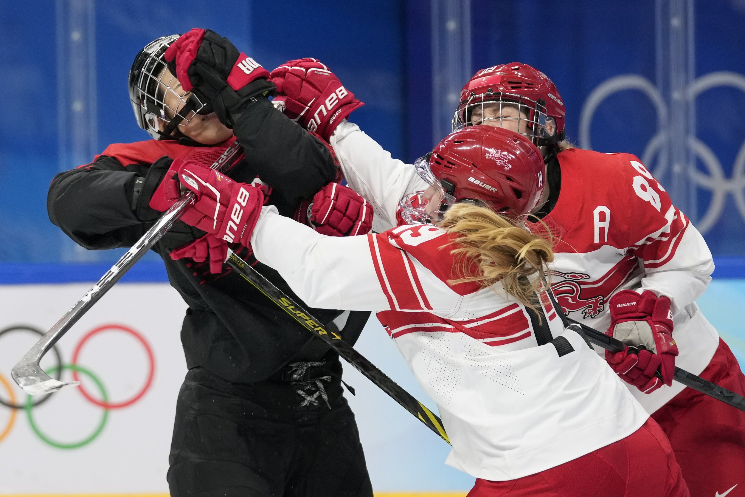  Denmark's Josephine Asperup (19) checks Japan's Rui Ukita, left, during a preliminary round women's hockey game at the 2022 Winter Olympics, Saturday, Feb. 5, 2022, in Beijing. (AP Photo/Petr David Josek) 