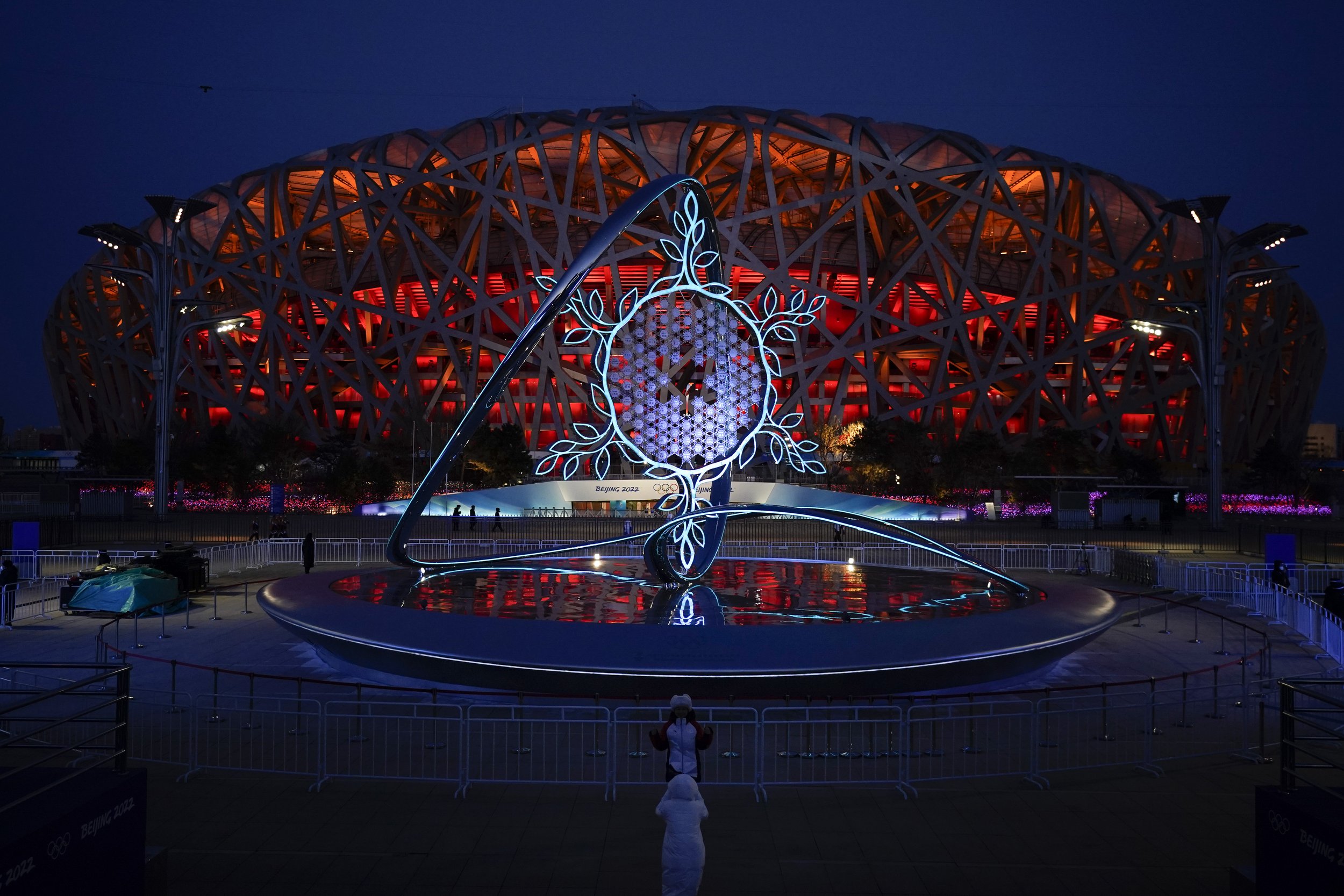 The Olympic flame burning in the center of the snowflake-shaped cauldron is on display near the National Stadium at the 2022 Winter Olympics, Saturday, Feb. 5, 2022, in Beijing. (AP Photo/Jae C. Hong) 