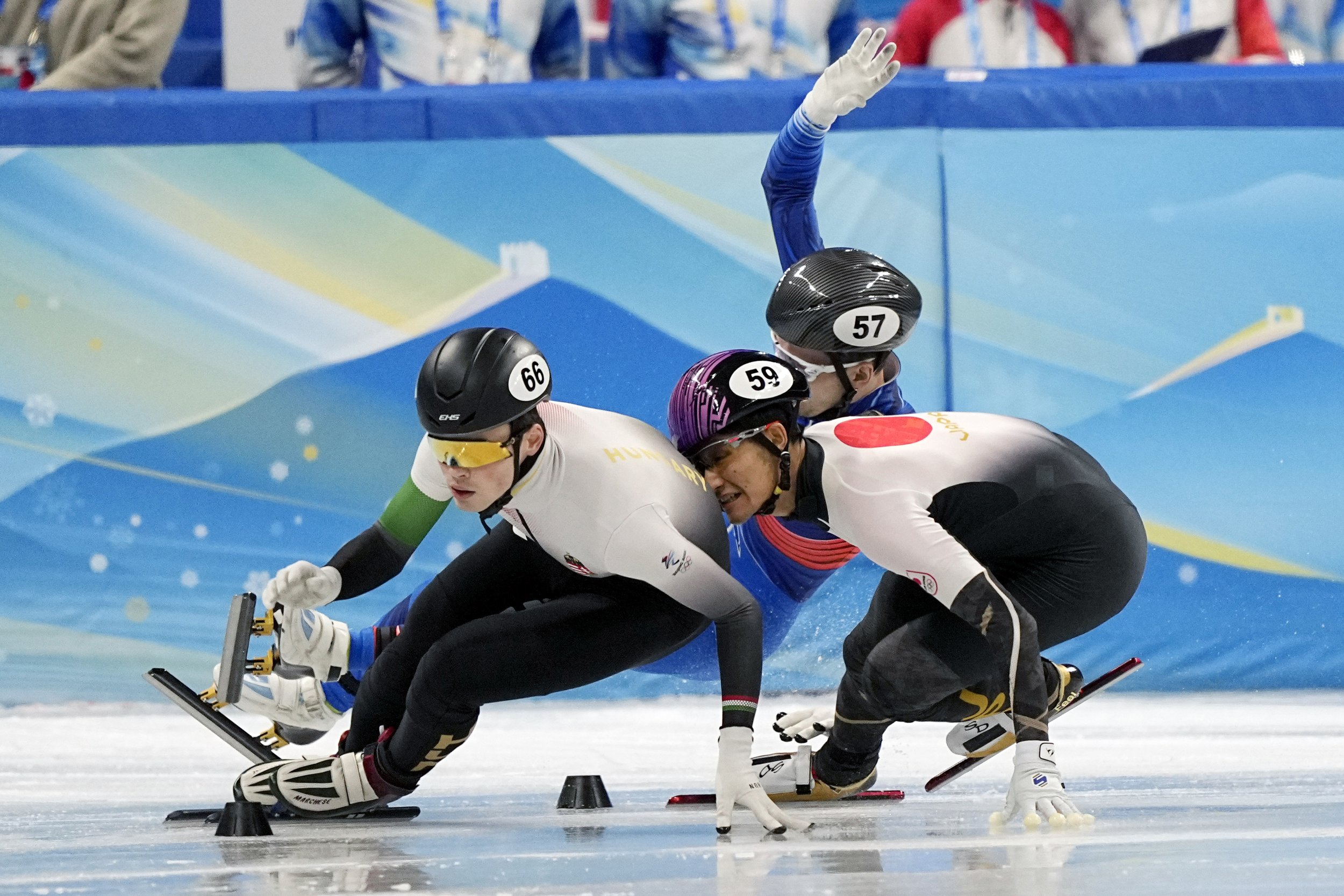  John-Henry Krueger, left, of Hungary leads Kazuki Yoshinaga of Japan and Denis Airapetian of the Russian Olympic Committee as they collide during their heat of the men's 1,000-meter the short track speedskating competition at the 2022 Winter Olympic
