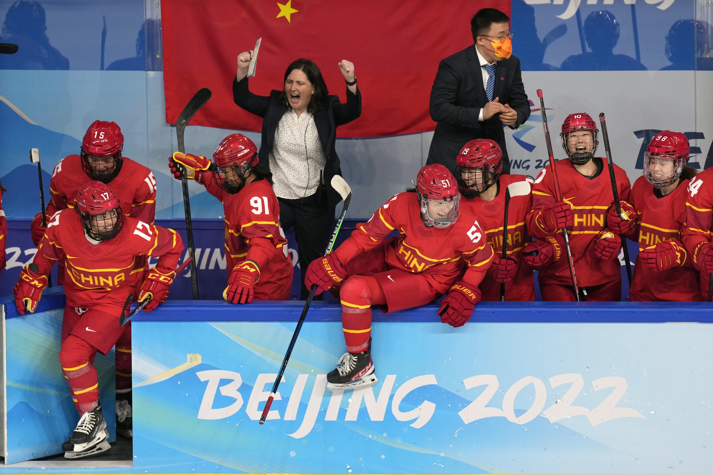  China players and coaches celebrate after beating Japan in a shoot-out during a preliminary round women's hockey game at the 2022 Winter Olympics, Sunday, Feb. 6, 2022, in Beijing. (AP Photo/Petr David Josek) 