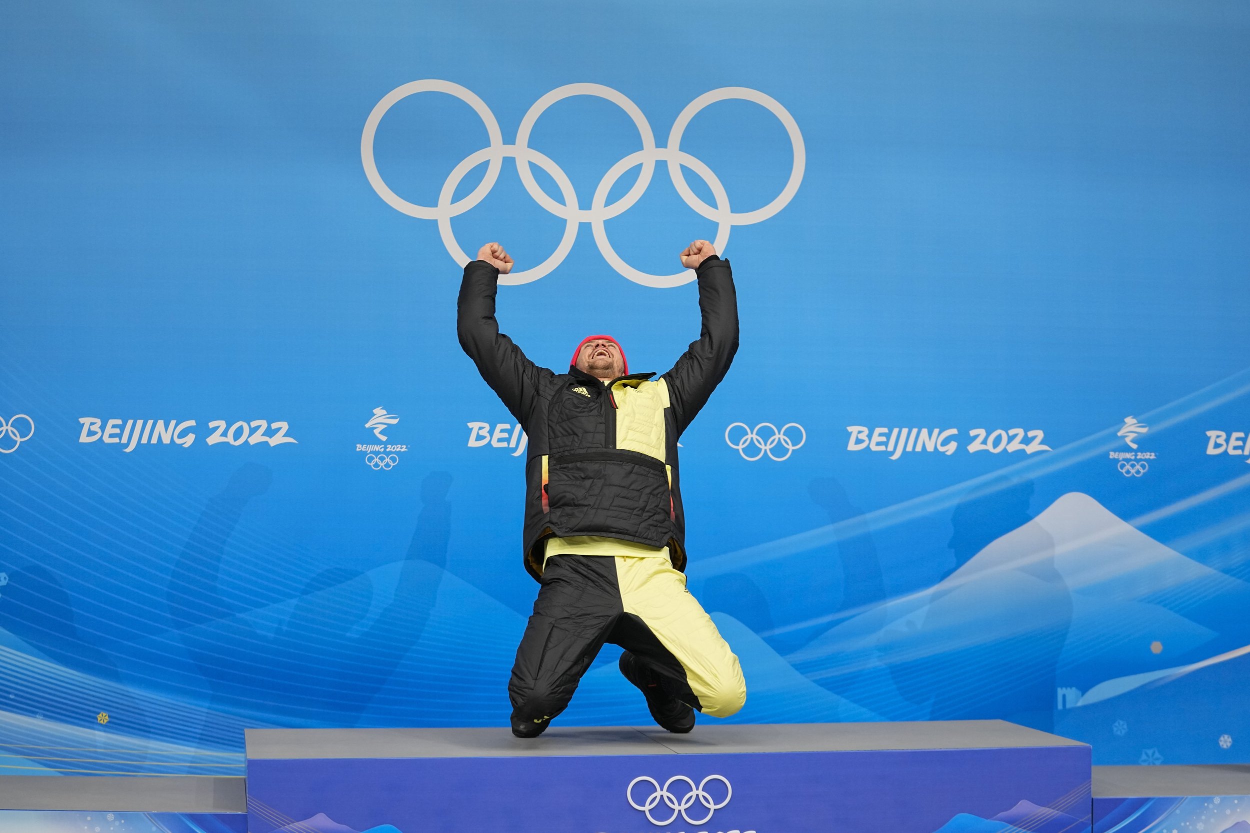  Johannes Ludwig, of Germany, kneels at the podium after winning the gold medal in luge men's single at the 2022 Winter Olympics, Sunday, Feb. 6, 2022, in the Yanqing district of Beijing. (AP Photo/Pavel Golovkin) 