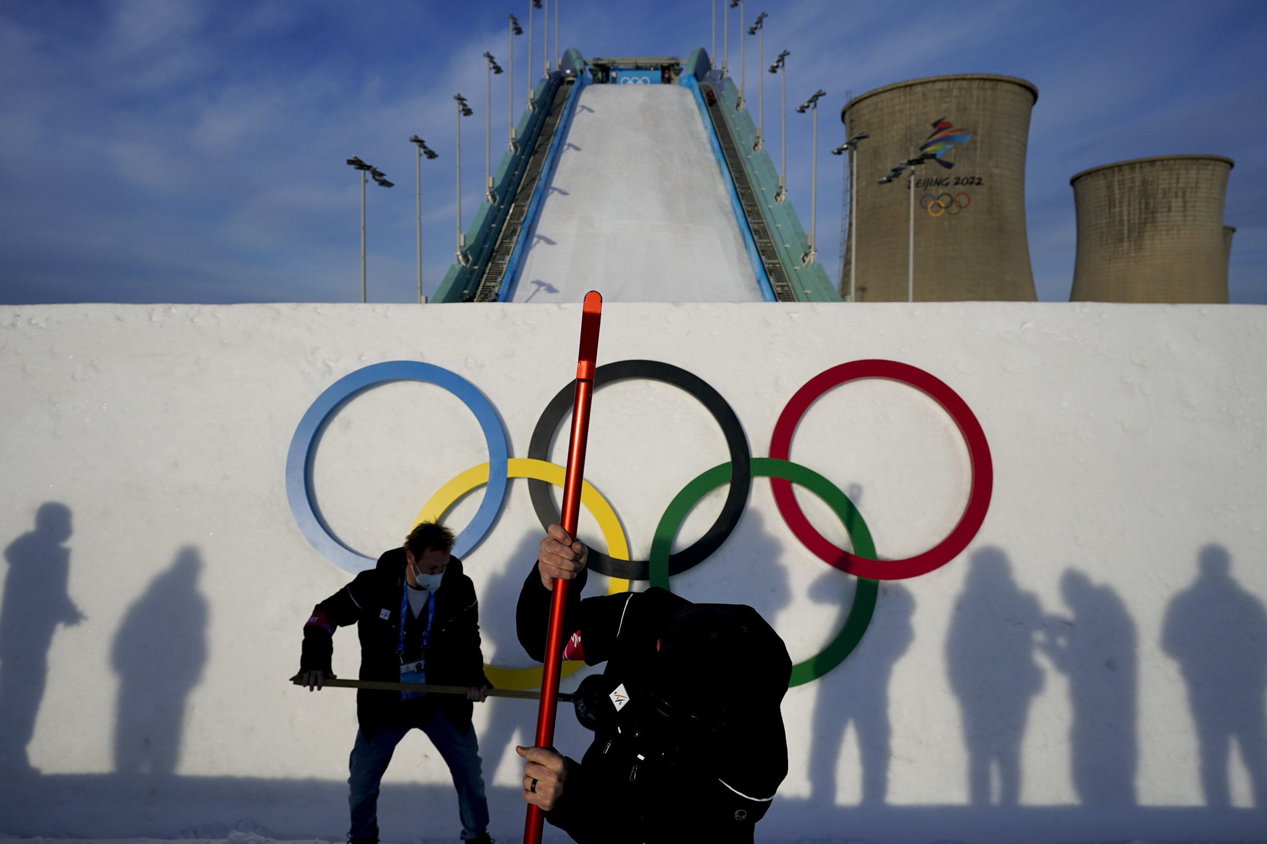  Two workers work around the kicker before a training session for the freestyle skiing big air competition at the 2022 Winter Olympics, Sunday, Feb. 6, 2022, in Beijing. (AP Photo/Jae C. Hong) 