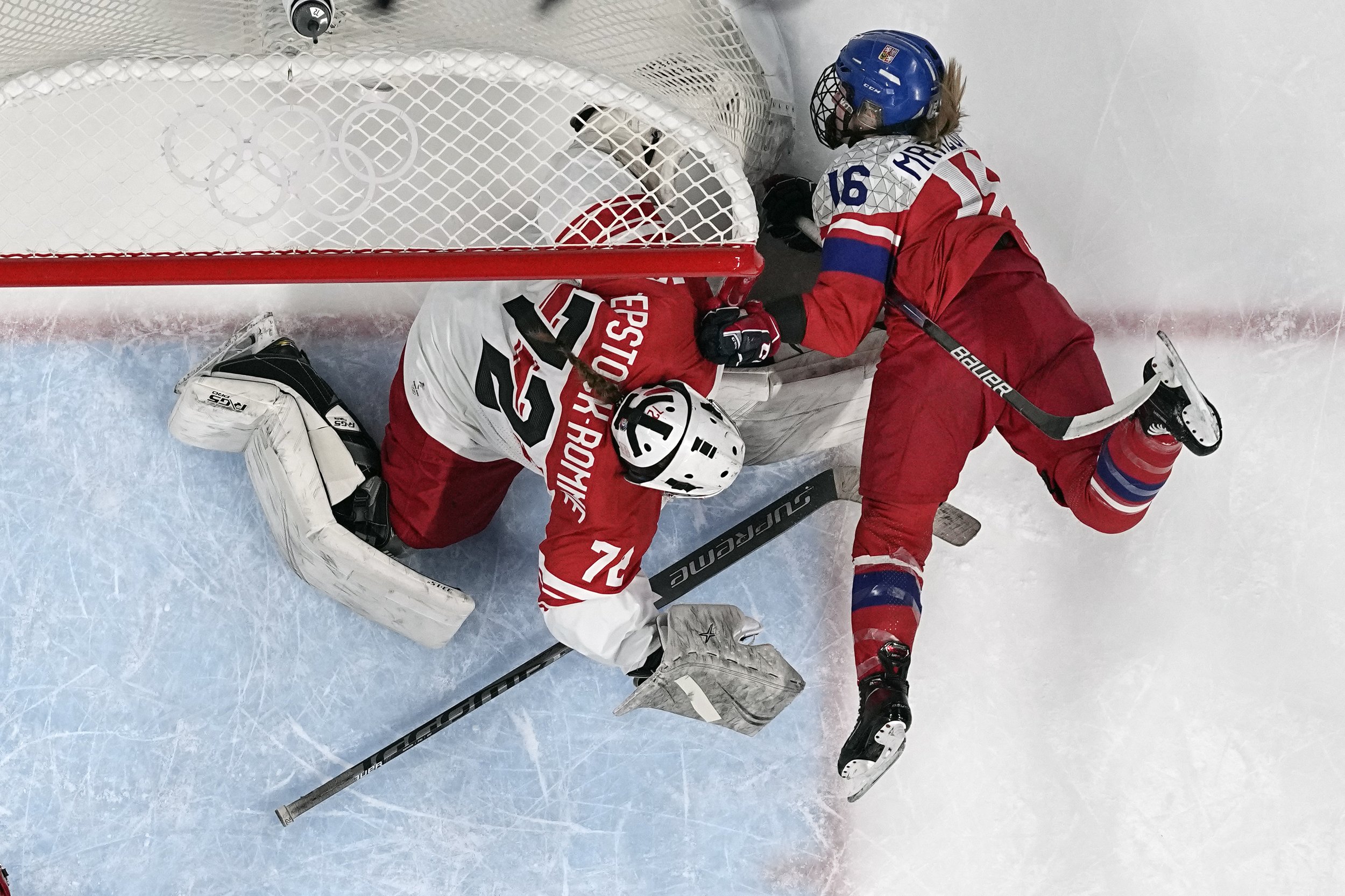  Czech Republic's Katerina Mrazova (16) falls against the net and Denmark goalkeeper Cassandra Repstock-Romme (72) during a preliminary round women's hockey game at the 2022 Winter Olympics, Monday, Feb. 7, 2022, in Beijing. (AP Photo/Petr David Jose