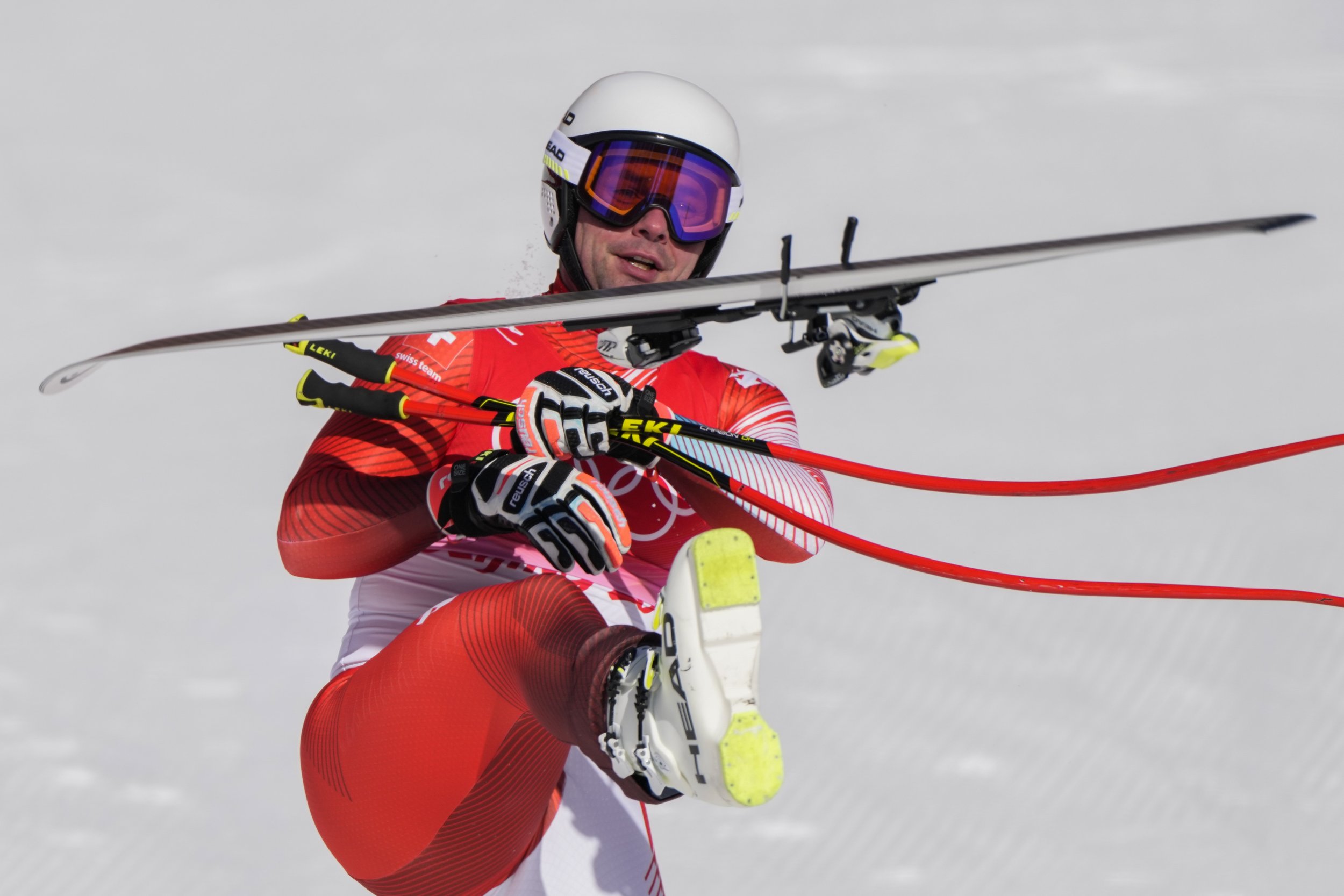  Beat Feuz, of Switzerland, kicks his ski after finishing the men's downhill at the 2022 Winter Olympics, Monday, Feb. 7, 2022, in the Yanqing district of Beijing. (AP Photo/Mark Schiefelbein) 