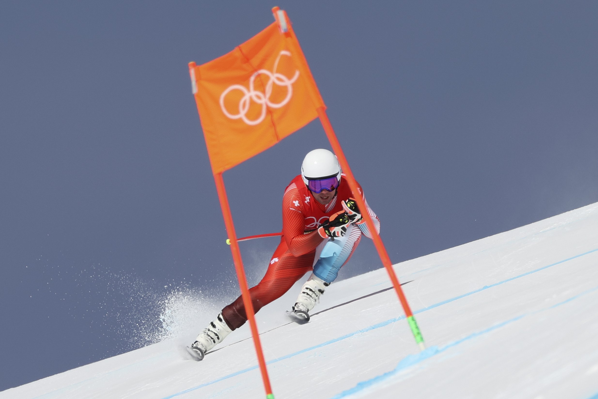  Beat Feuz, of Switzerland, makes a turn in the men's downhill at the 2022 Winter Olympics, Monday, Feb. 7, 2022, in the Yanqing district of Beijing. (AP Photo/Alessandro Trovati) 