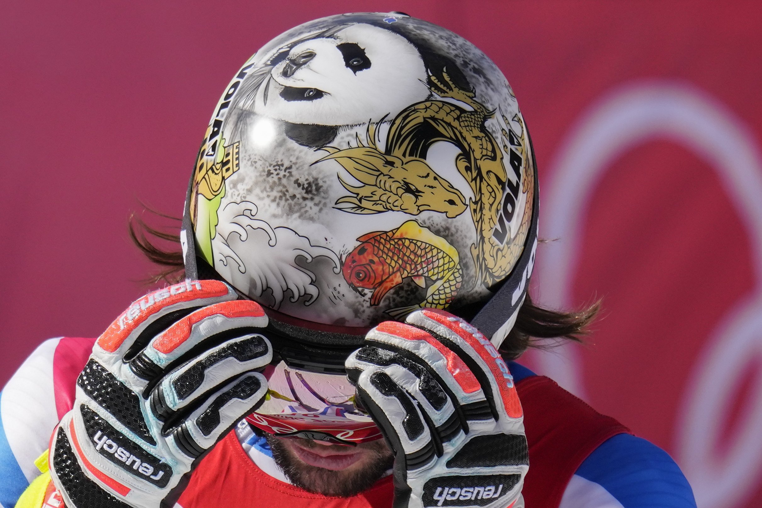 Matthieu Bailet, of France, removes his googles after finishing the men's downhill at the 2022 Winter Olympics, Monday, Feb. 7, 2022, in the Yanqing district of Beijing. (AP Photo/Luca Bruno) 