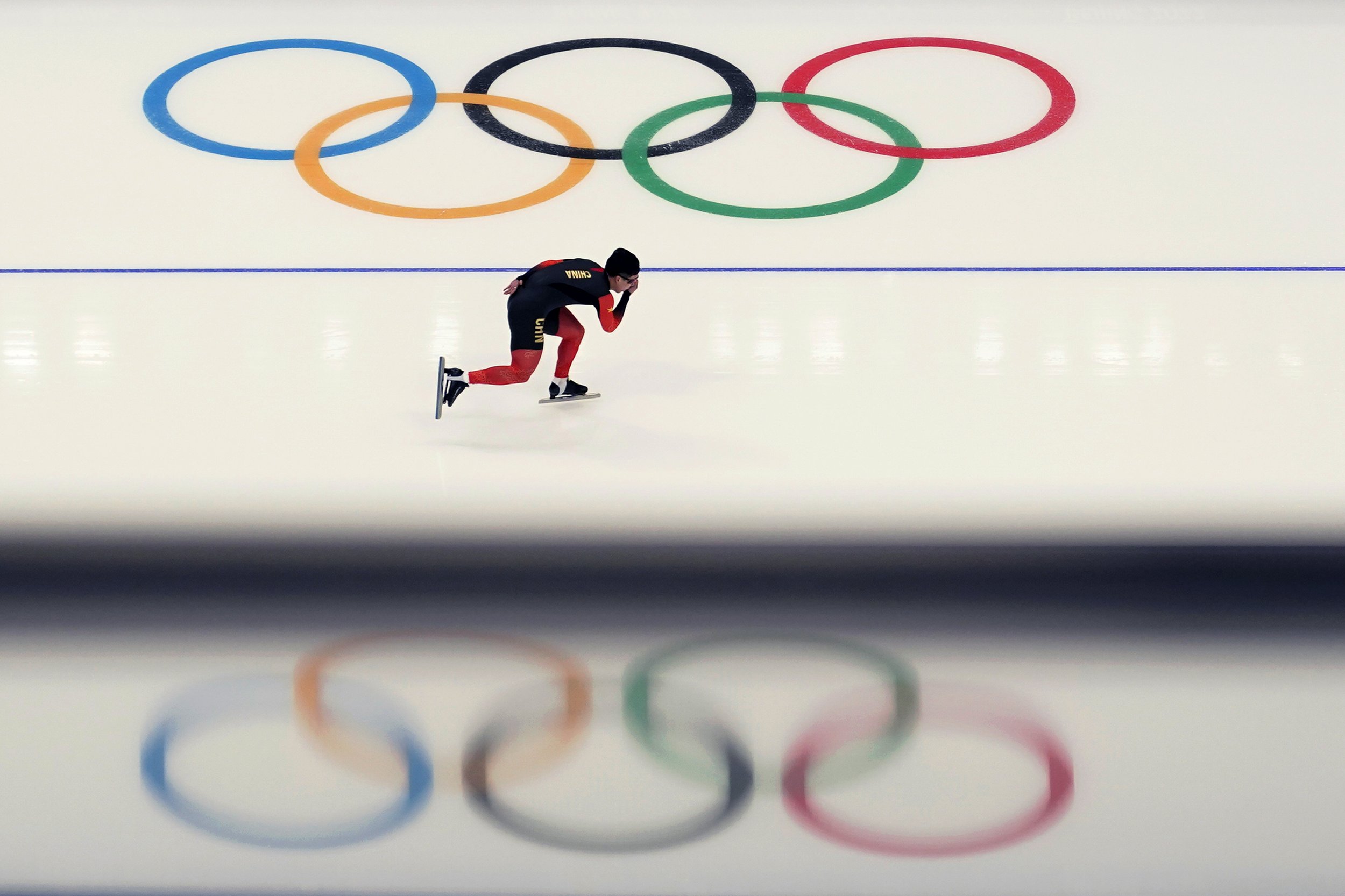 A Chinese athlete warms up before the start of the men's speedskating 1,500-meter race at the 2022 Winter Olympics, Tuesday, Feb. 8, 2022, in Beijing. (AP Photo/Ashley Landis) 