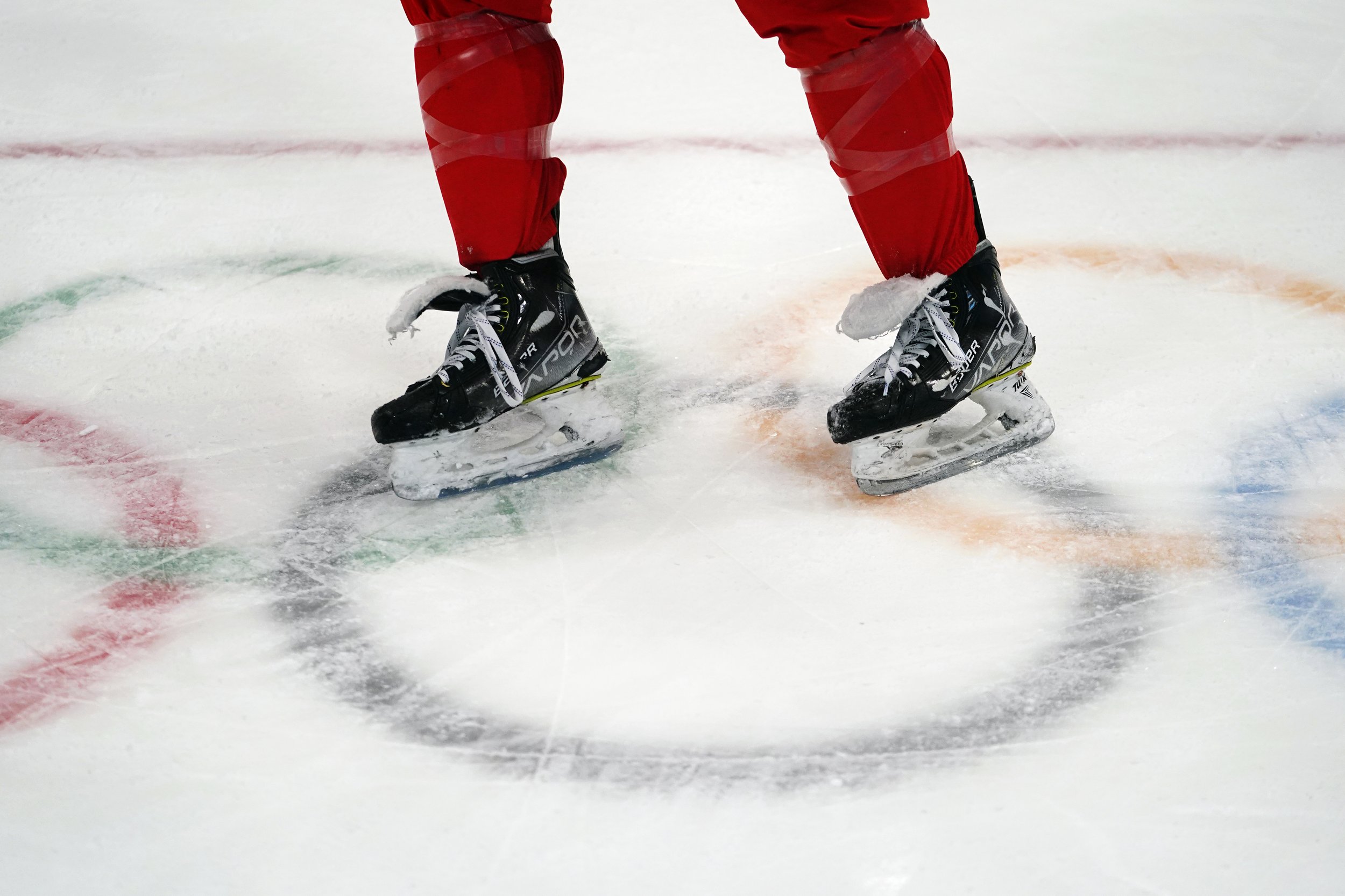  A member of the China men's hockey team skates across the Olympic rings during a practice session at the National Indoor Stadium ahead of the 2022 Winter Olympics, Tuesday, Feb. 1, 2022, in Beijing. (AP Photo/Matt Slocum) 