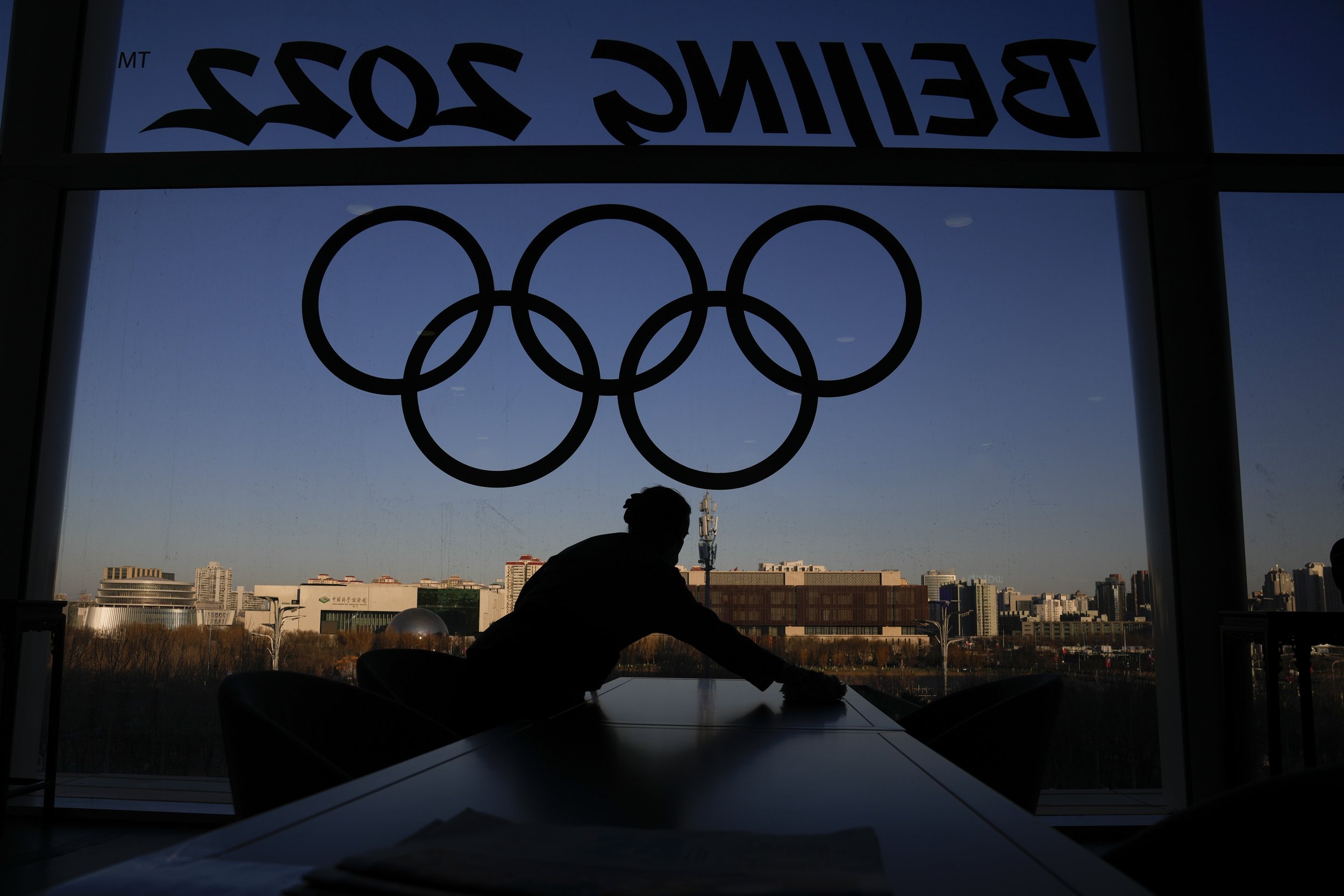  A woman cleans a table at the Olympics Main Media Center ahead of the 2022 Winter Olympics, Tuesday, Feb. 1, 2022, in Beijing. (AP Photo/Natacha Pisarenko) 