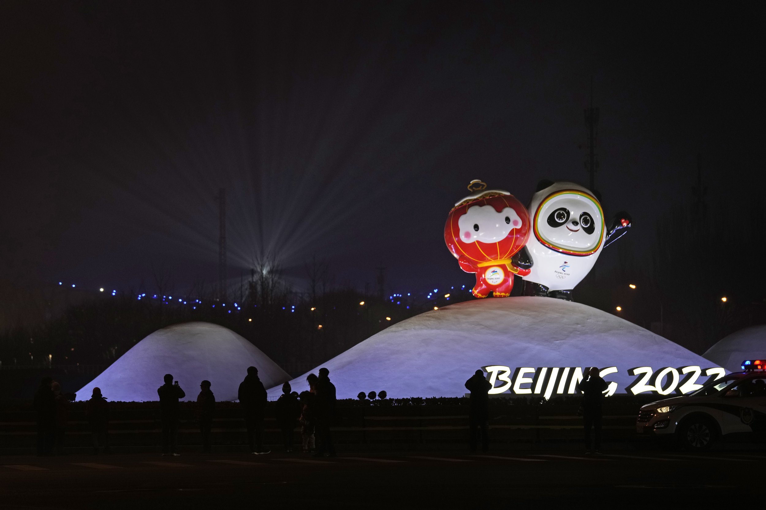  Residents past near the Paralympic mascot Shuey Rhon Rhon left, and Winter Olympic mascot Bing Dwen Dwen displayed near the National Stadium where a rehearsal for the opening ceremony of the 2022 Winter Olympics is taking place, in Beijing, China, J