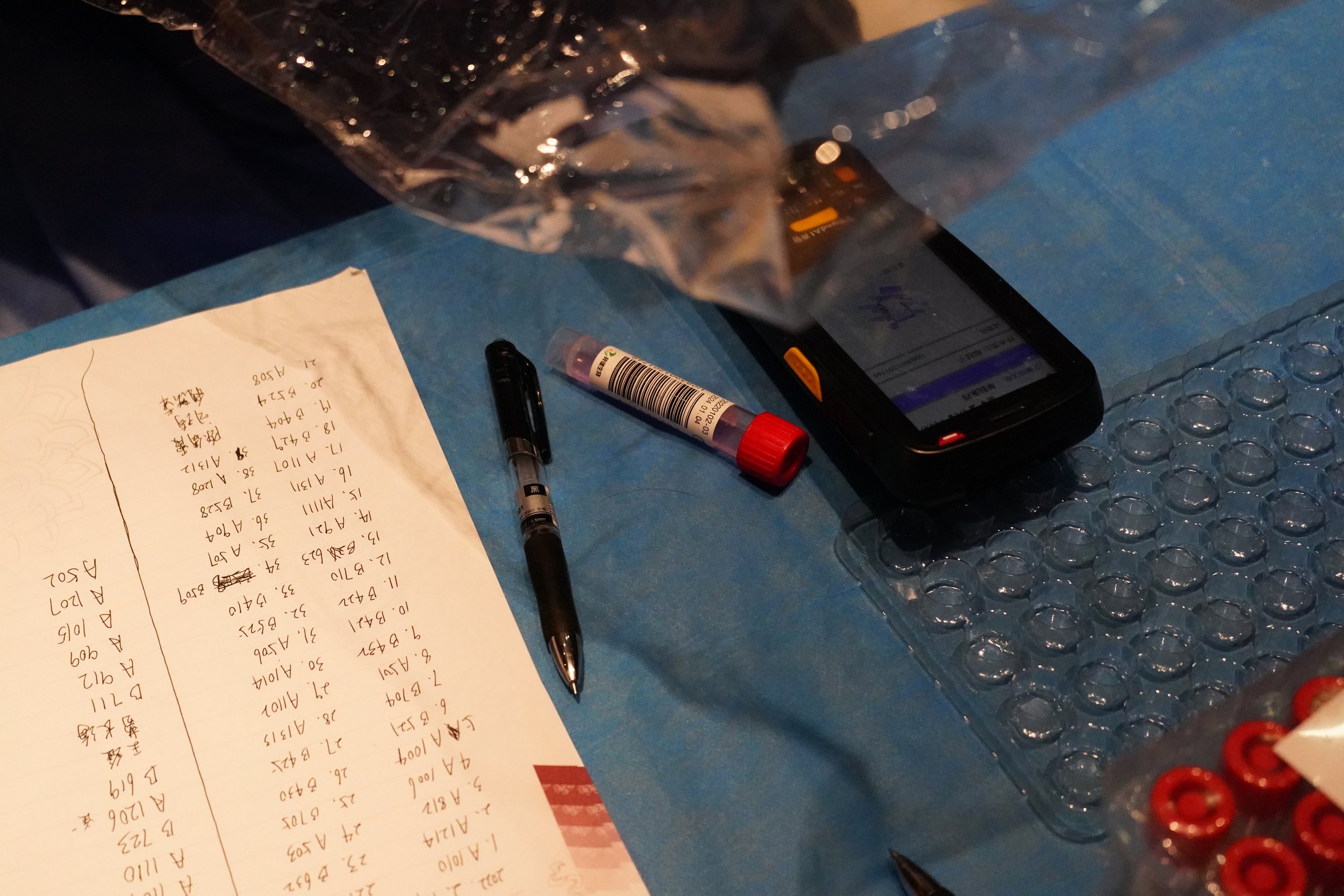  A medical worker prepares a testing kit for Associated Press photographer Matt Slocum after testing positive that morning at a hotel during the 2022 Winter Olympics, Feb. 9, 2022, in Beijing. (AP Photo/Matt Slocum) 