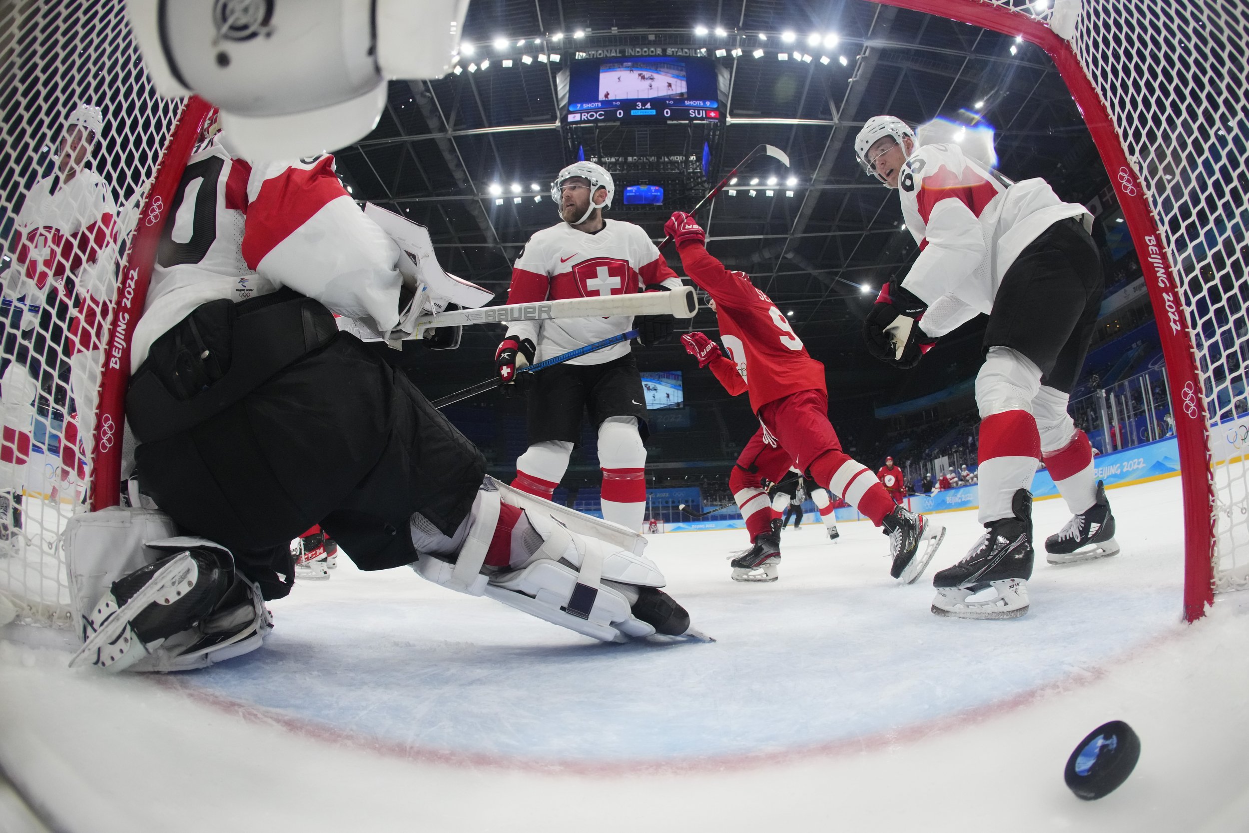  Russian Olympic Committee's Kirill Semyonov (94), second from right, celebrates after a shot by teammate Anton Slepyshev, not shown, gets past Switzerland's goalkeeper Reto Berra (20) for a goal during a preliminary round men's hockey game at the 20