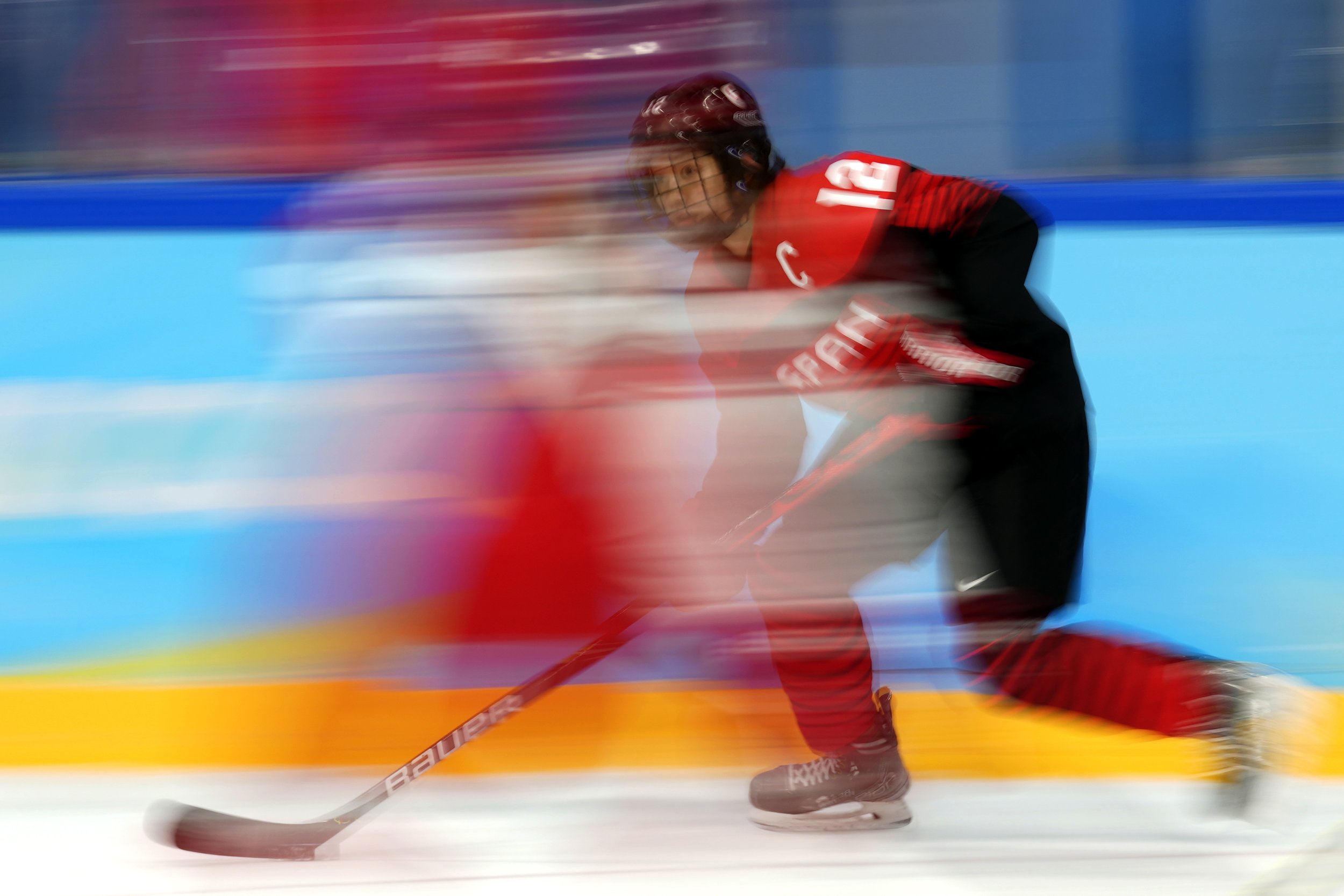  Japan's Chiho Osawa (12) moves the puck during a preliminary round womenÕs hockey game against Denmark at the 2022 Winter Olympics, Saturday, Feb. 5, 2022, in Beijing. (AP Photo/Petr David Josek) 