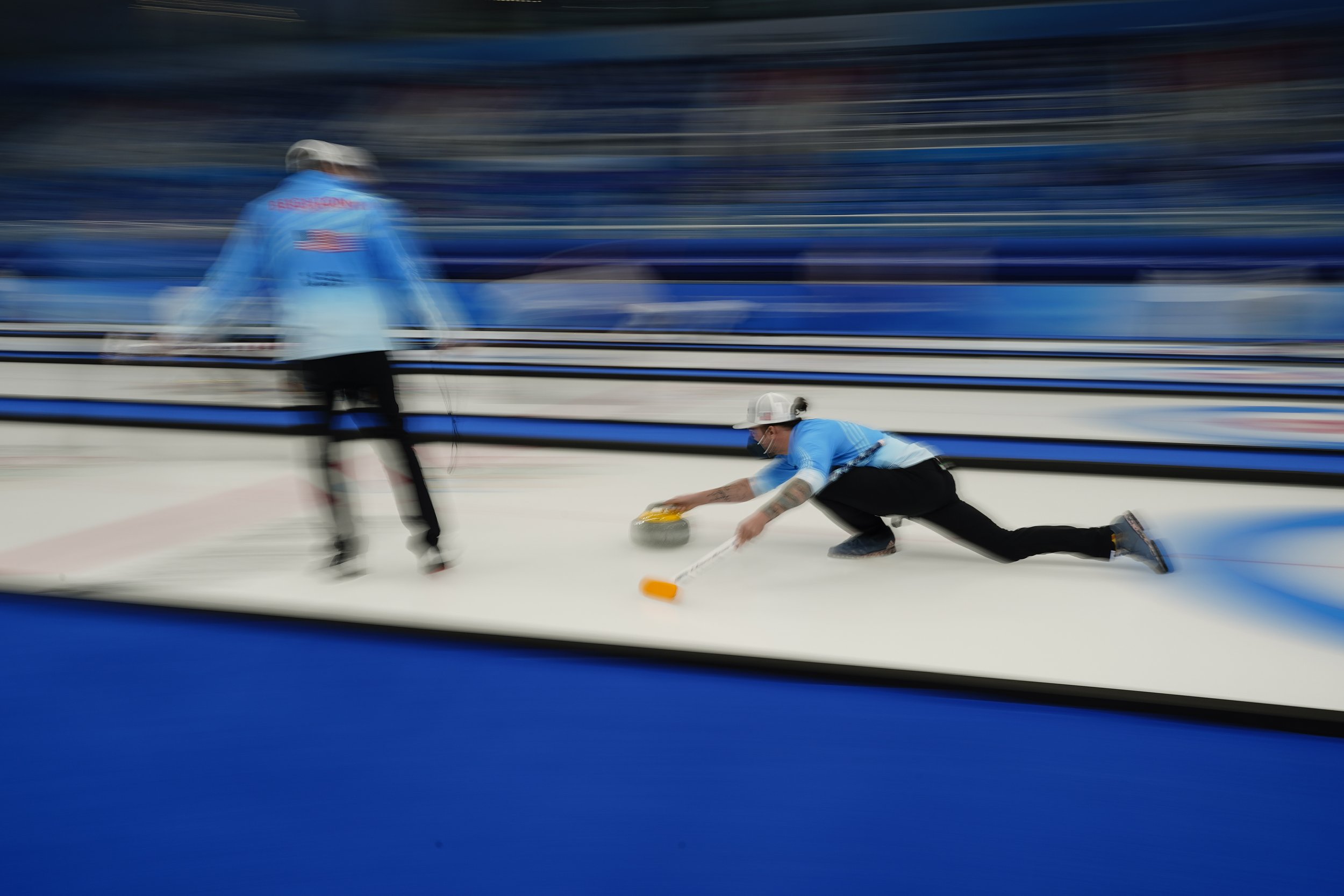  Christopher Plys, of the United States, throws a rock during practice before the mixed doubles curling match against China at the Beijing Winter Olympics Saturday, Feb. 5, 2022, in Beijing. (AP Photo/Brynn Anderson) 