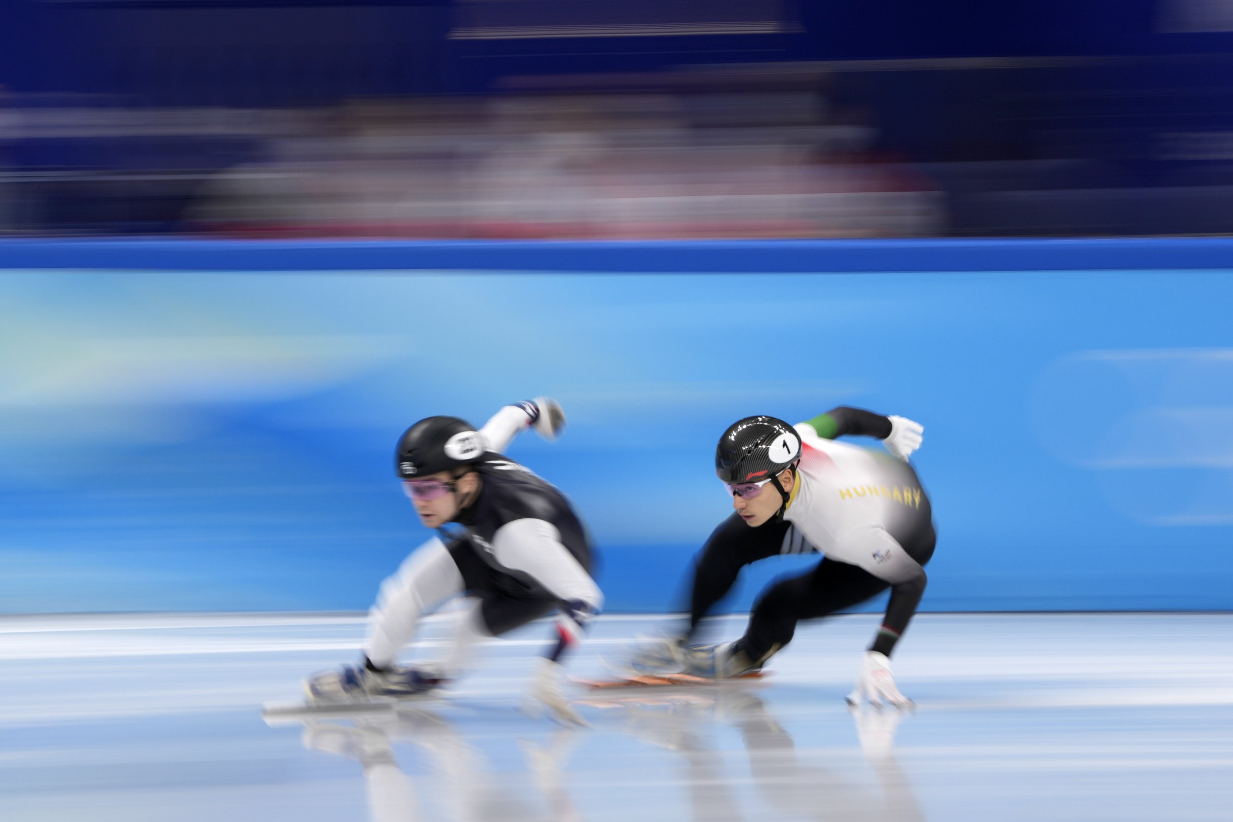  Andrew Heo, left, of the United States, and Liu Shaoang of Hungary race in the mixed team relay semifinal during the short track speedskating competition at the 2022 Winter Olympics, Saturday, Feb. 5, 2022, in Beijing. (AP Photo/Natacha Pisarenko) 