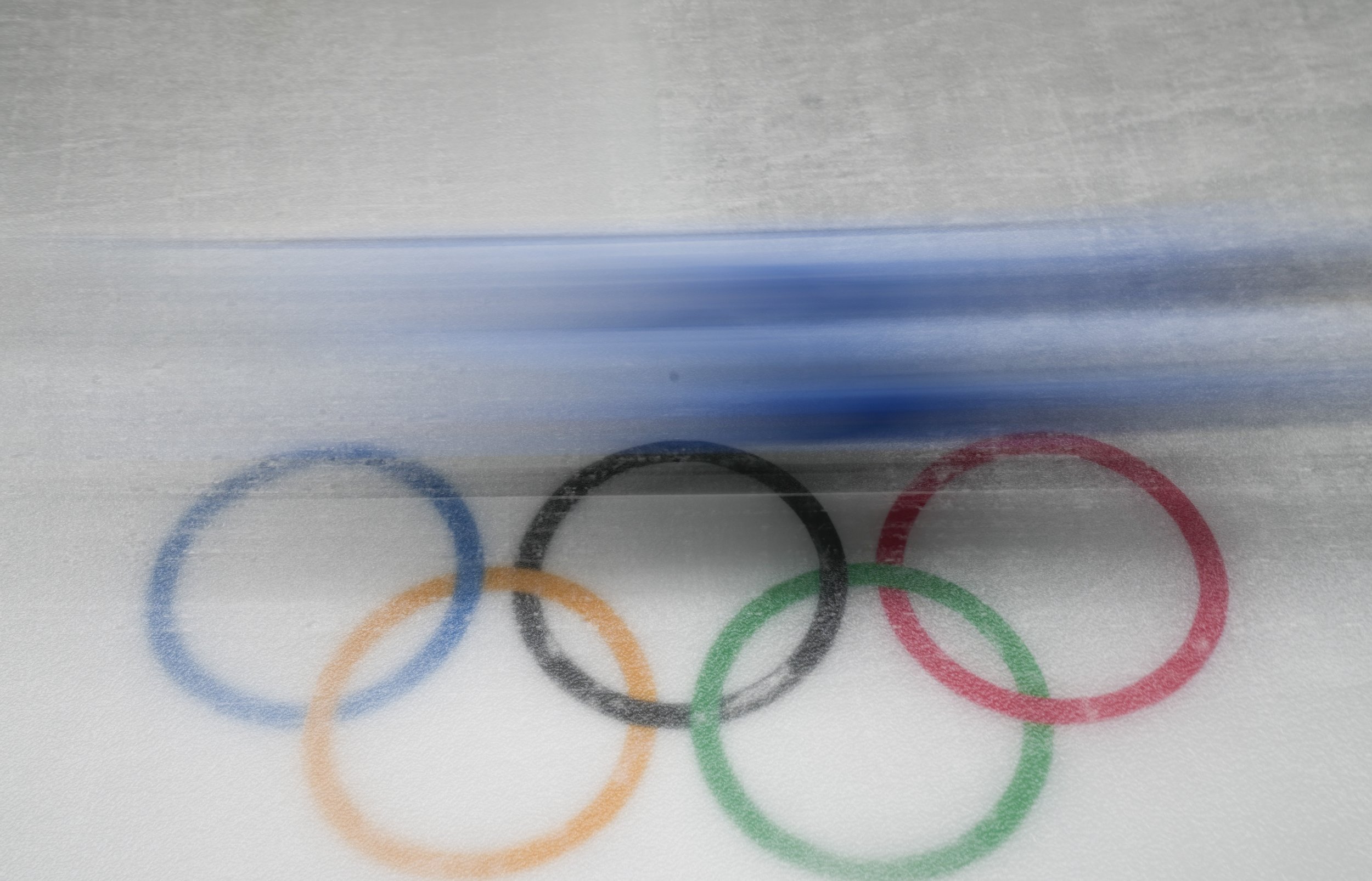  A competitor slides past the Olympic rings during the luge women's singles run 1 at the 2022 Winter Olympics, Monday, Feb. 7, 2022, in the Yanqing district of Beijing. (AP Photo/Pavel Golovkin) 