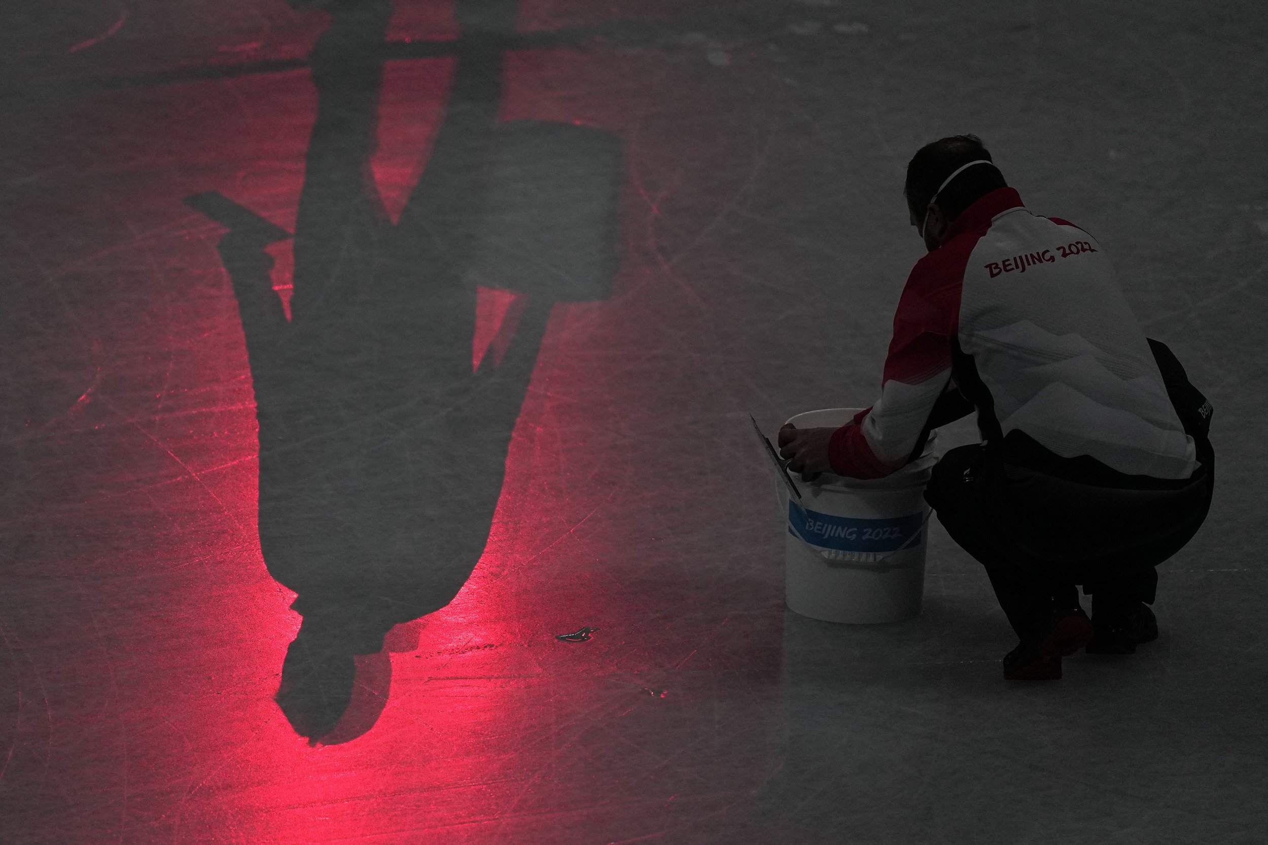  Workers repair the ice before the men's free skate program during the figure skating event at the 2022 Winter Olympics, Thursday, Feb. 10, 2022, in Beijing. (AP Photo/Jae C. Hong) 