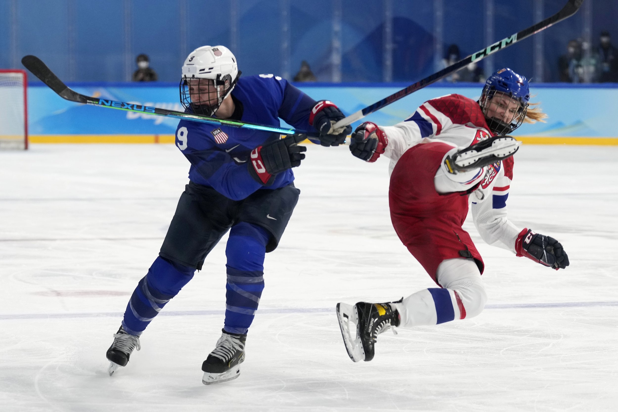  Czech Republic's Daniela Pejsova, right, falls next to United States' Megan Bozek (9) during a women's quarterfinal hockey game at the 2022 Winter Olympics, Friday, Feb. 11, 2022, in Beijing. (AP Photo/Petr David Josek) 