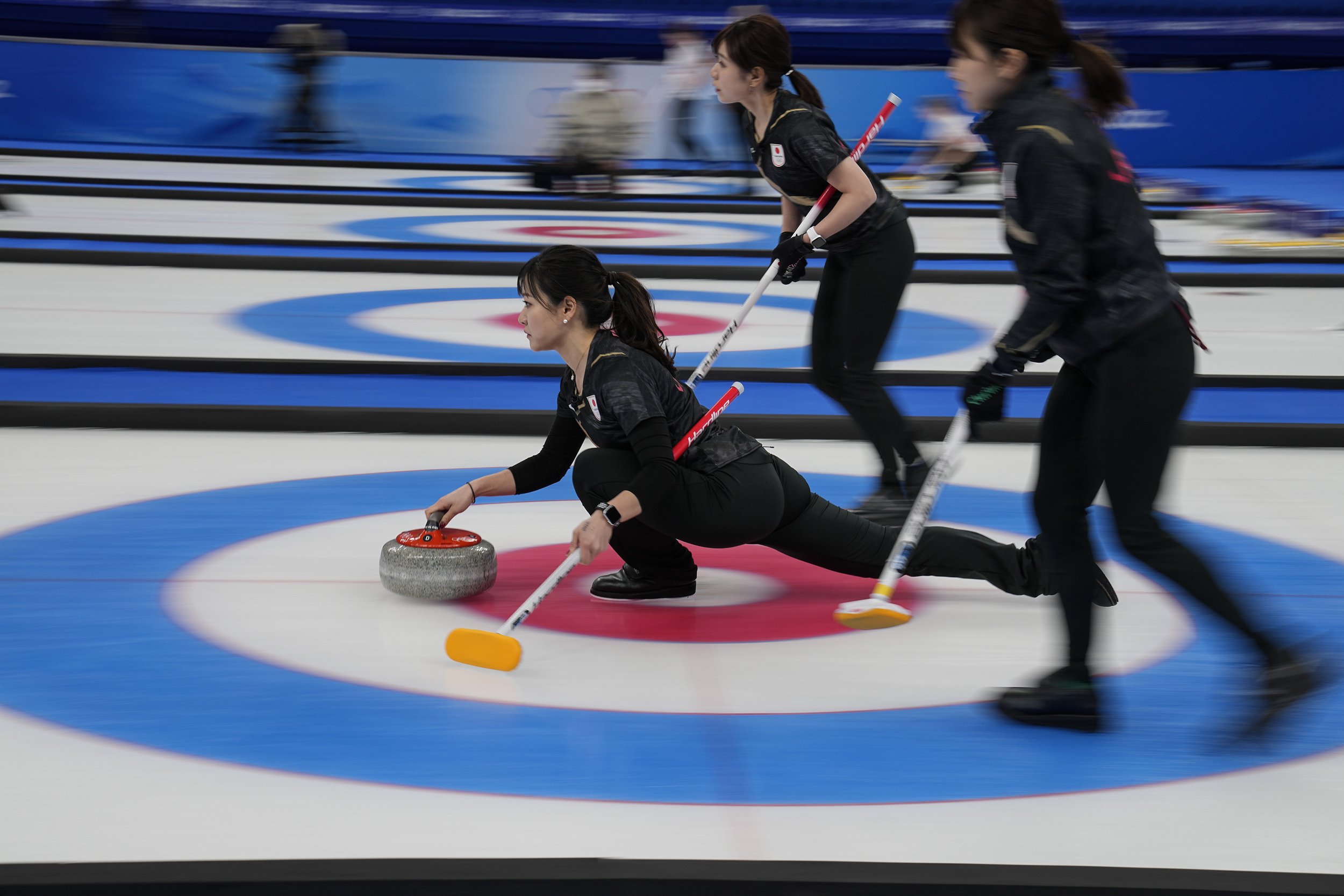  Japan's Chinami Yoshida throws a rock during a women's curling match against Denmark at the Beijing Winter Olympics Saturday, Feb. 12, 2022, in Beijing. (AP Photo/Brynn Anderson) 