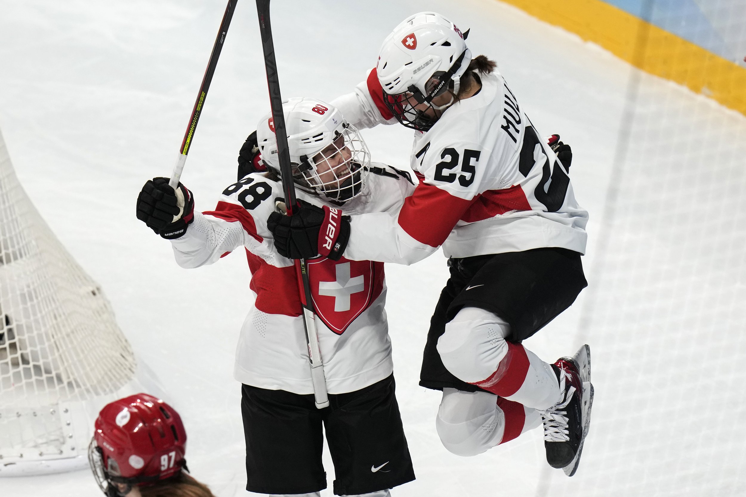 Switzerland's Phoebe Staenz (88) celebrates her goal with teammate Alina Muller (25) against the Russian Olympic Committee during a women's quarterfinal hockey game at the 2022 Winter Olympics, Saturday, Feb. 12, 2022, in Beijing. (AP Photo/Petr Dav