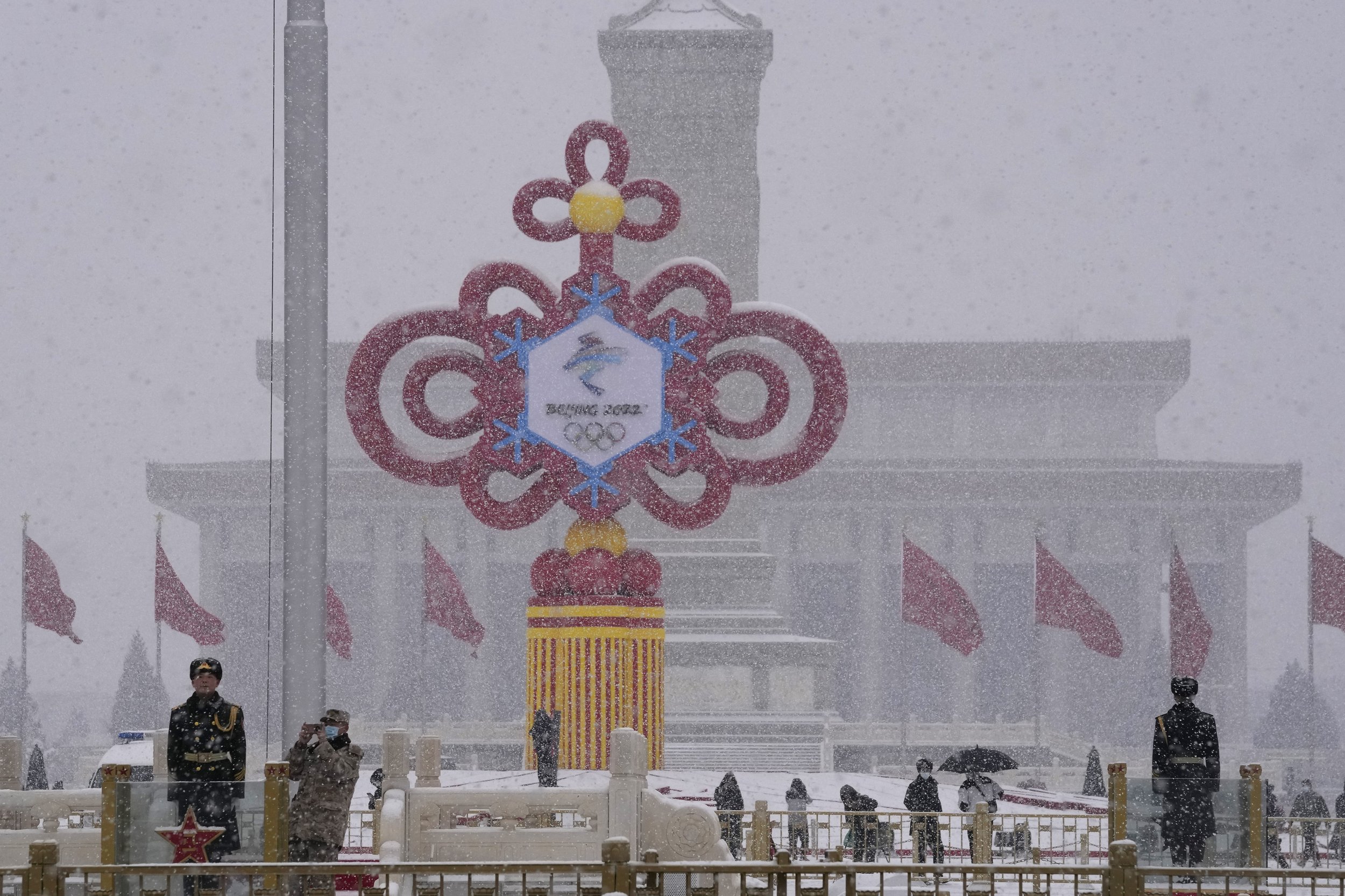  A giant decoration for the 2022 Winter Olympics stands on Tiananmen Square as it snows in Beijing on Sunday, Feb. 13, 2022. (AP Photo/Ng Han Guan) 