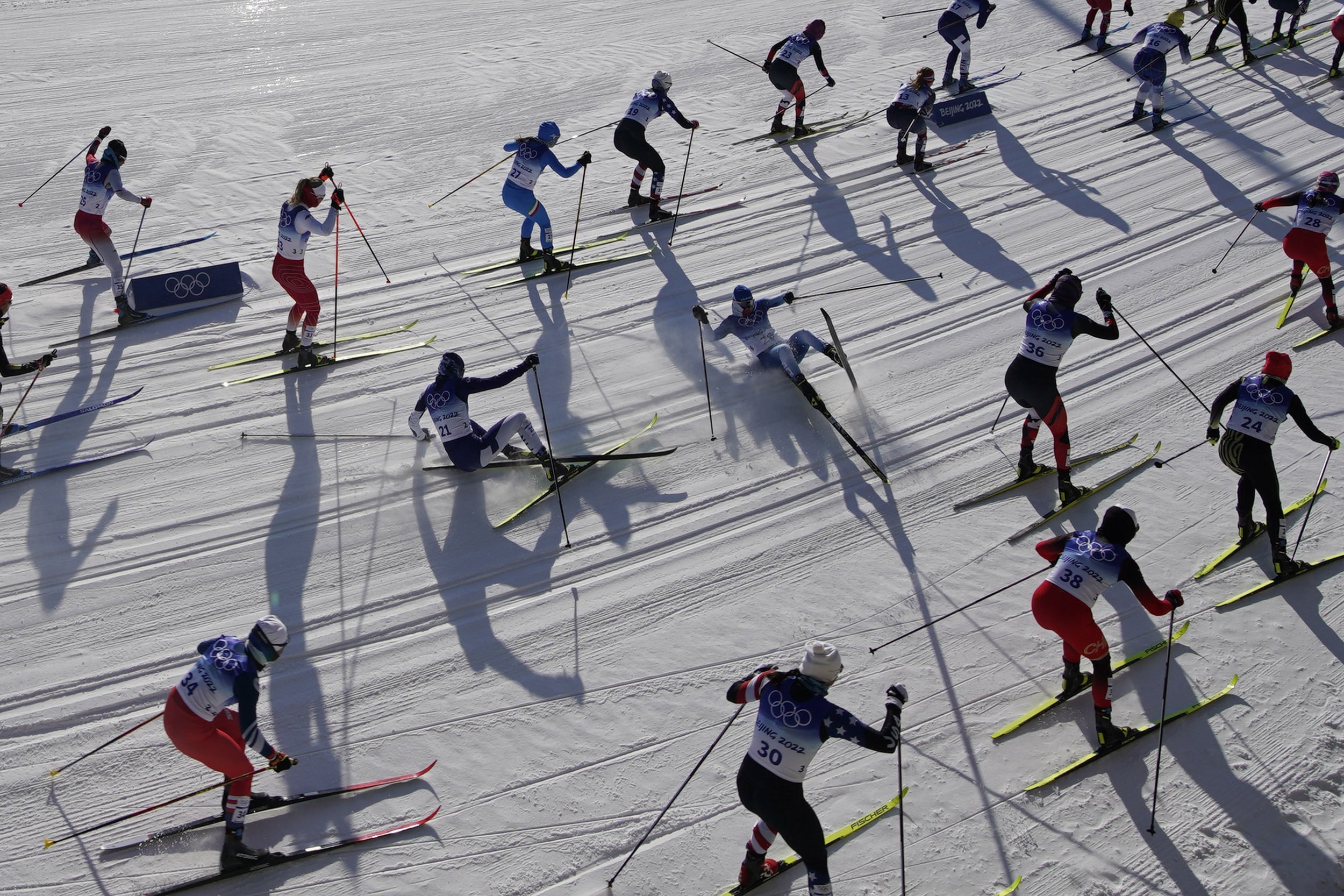  Skiers fall while competing during the women's 7.5km + 7.5km Skiathlon cross-country skiing competition at the 2022 Winter Olympics, Saturday, Feb. 5, 2022, in Zhangjiakou, China. (AP Photo/John Locher) 