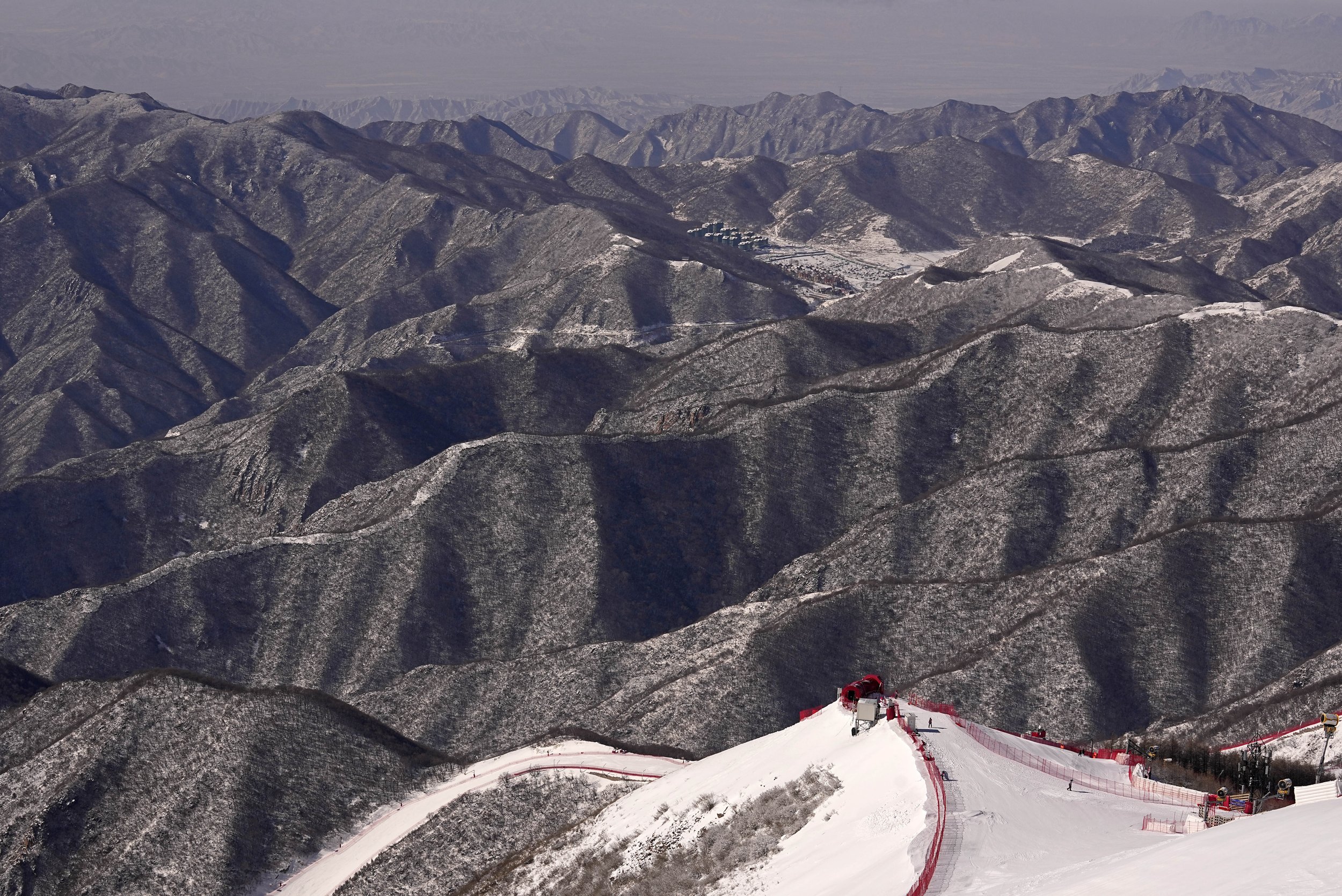  A view from the summit, near the start of the downhill course at the alpine ski venue at the 2022 Winter Olympics, Monday, Feb. 14, 2022, in the Yanqing district of Beijing. (AP Photo/Robert F. Bukaty) 