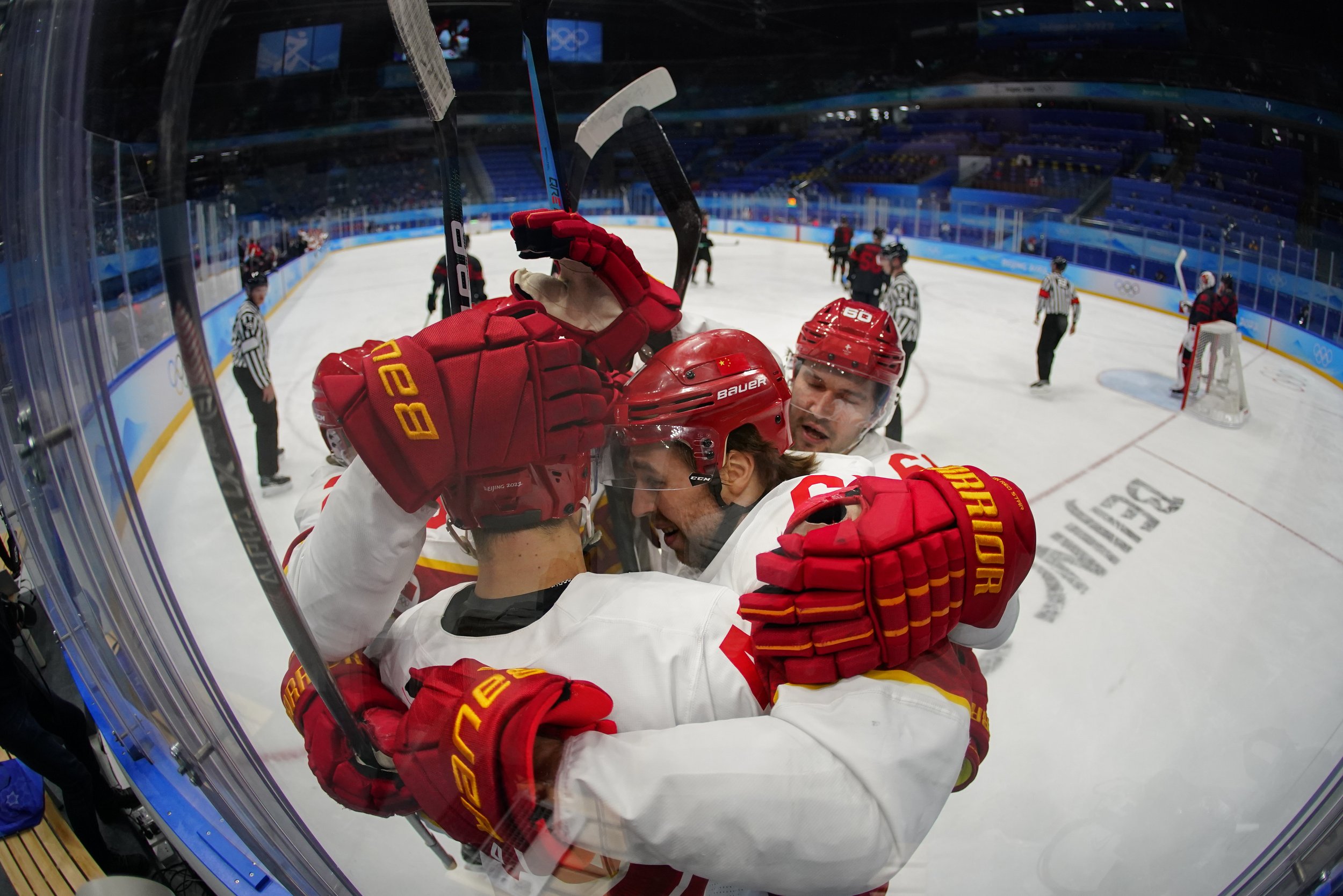  China's Jian An (Cory Kane), front left, is congratulated after scoring a goal against Canada during a men's qualification round hockey game at the 2022 Winter Olympics, Tuesday, Feb. 15, 2022, in Beijing. (AP Photo/Matt Slocum) 