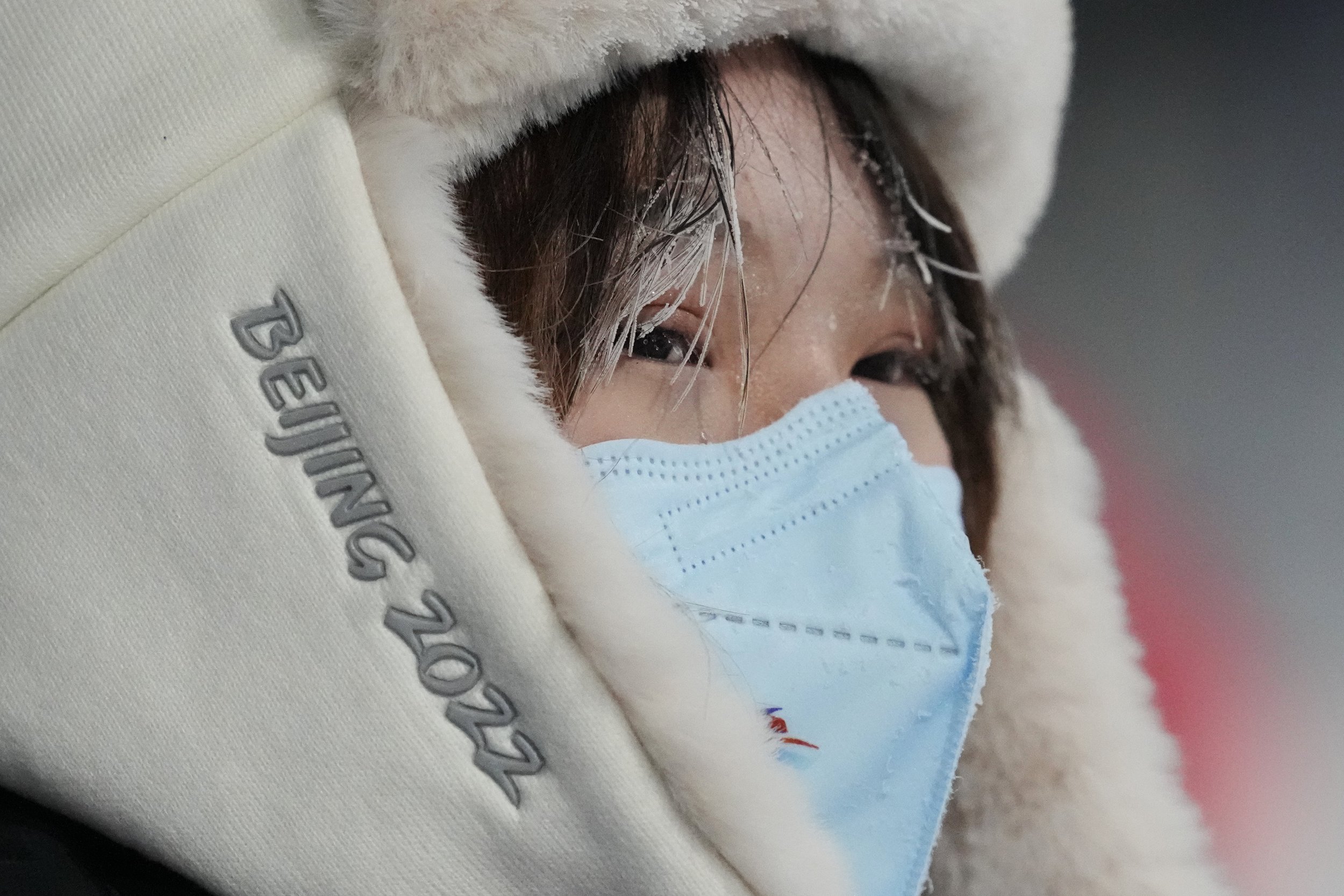  Icicles hang down on the hair of a volunteer during the men's aerials qualification at the 2022 Winter Olympics, Tuesday, Feb. 15, 2022, in Zhangjiakou, China. (AP Photo/Lee Jin-man) 