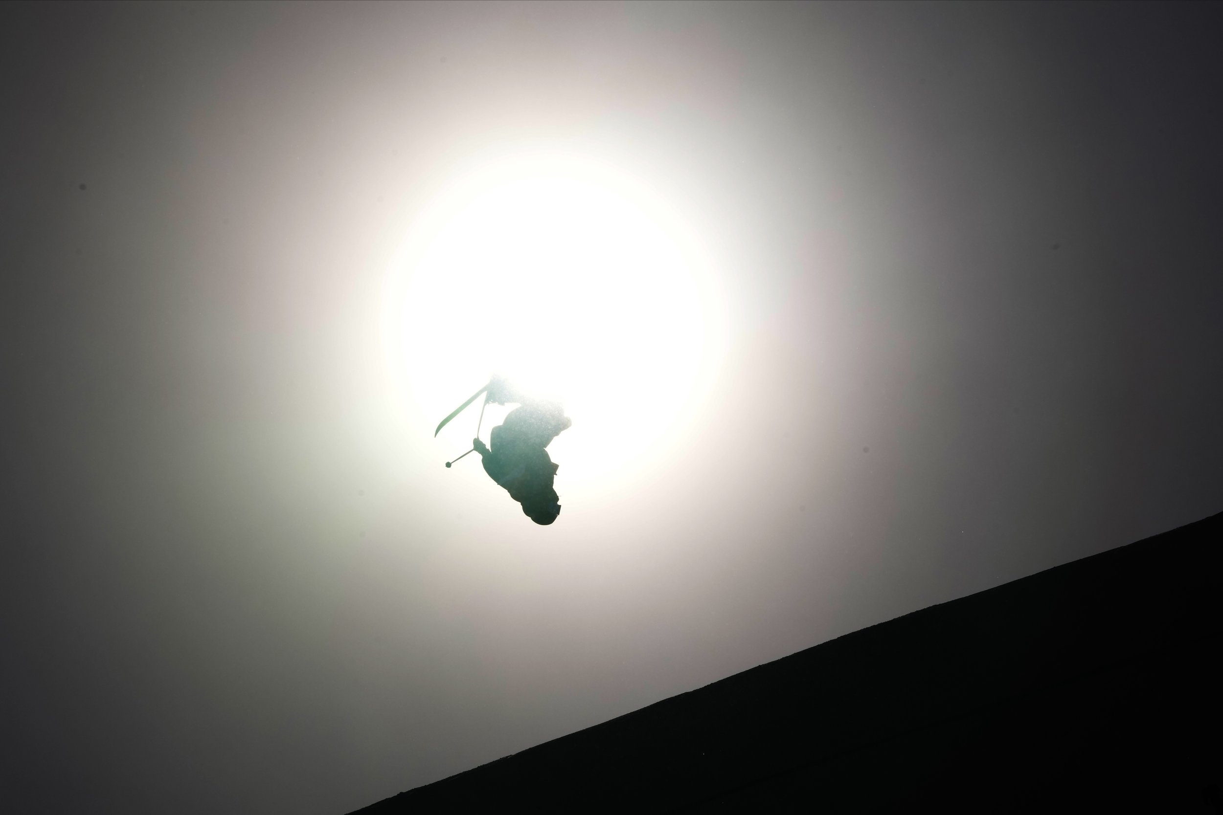  Switzerland's Andri Ragettli is silhouetted in front of the sun as he competes during the men's slopestyle qualification at the 2022 Winter Olympics, Tuesday, Feb. 15, 2022, in Zhangjiakou, China. (AP Photo/Francisco Seco) 