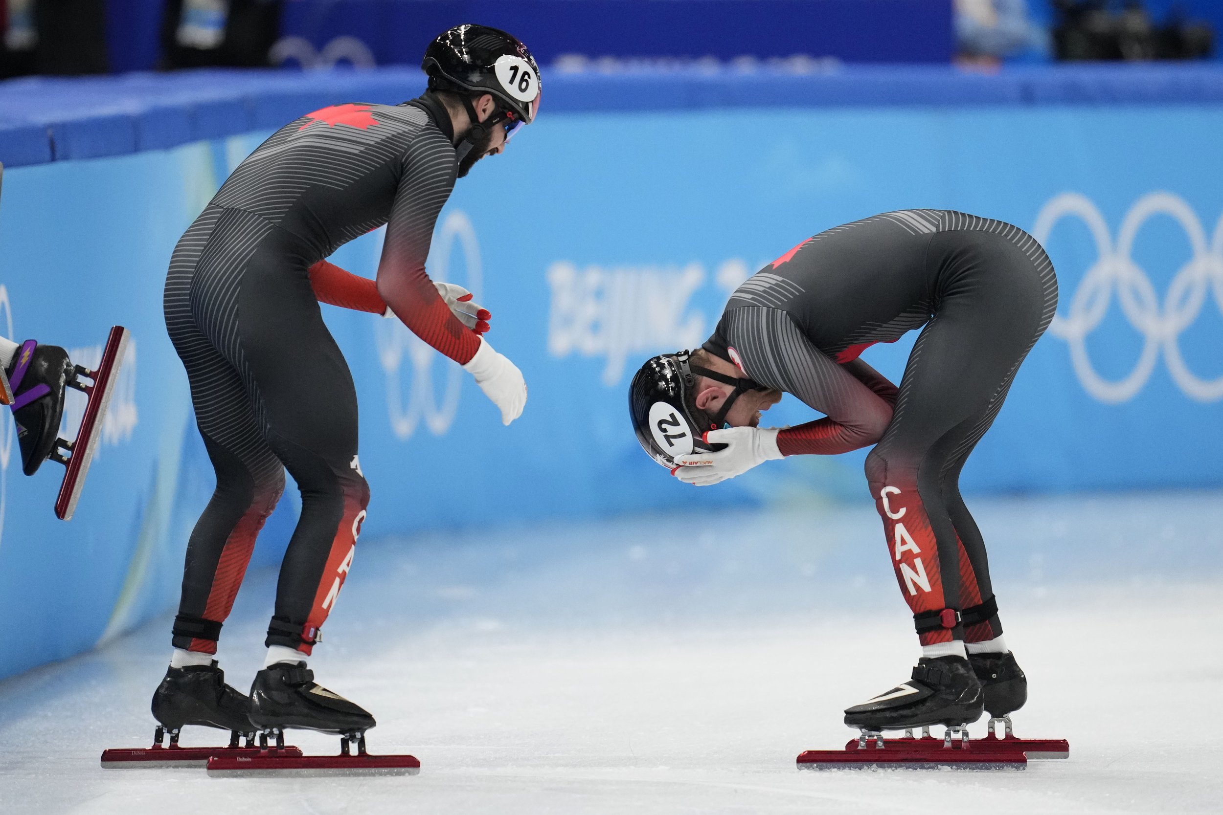  Steven Dubois, left, of team Canada, and teammate Pascal Dion celebrate after winning the men's 5000-meters relay final during the short track speedskating competition at the 2022 Winter Olympics, Wednesday, Feb. 16, 2022, in Beijing. (AP Photo/Nata