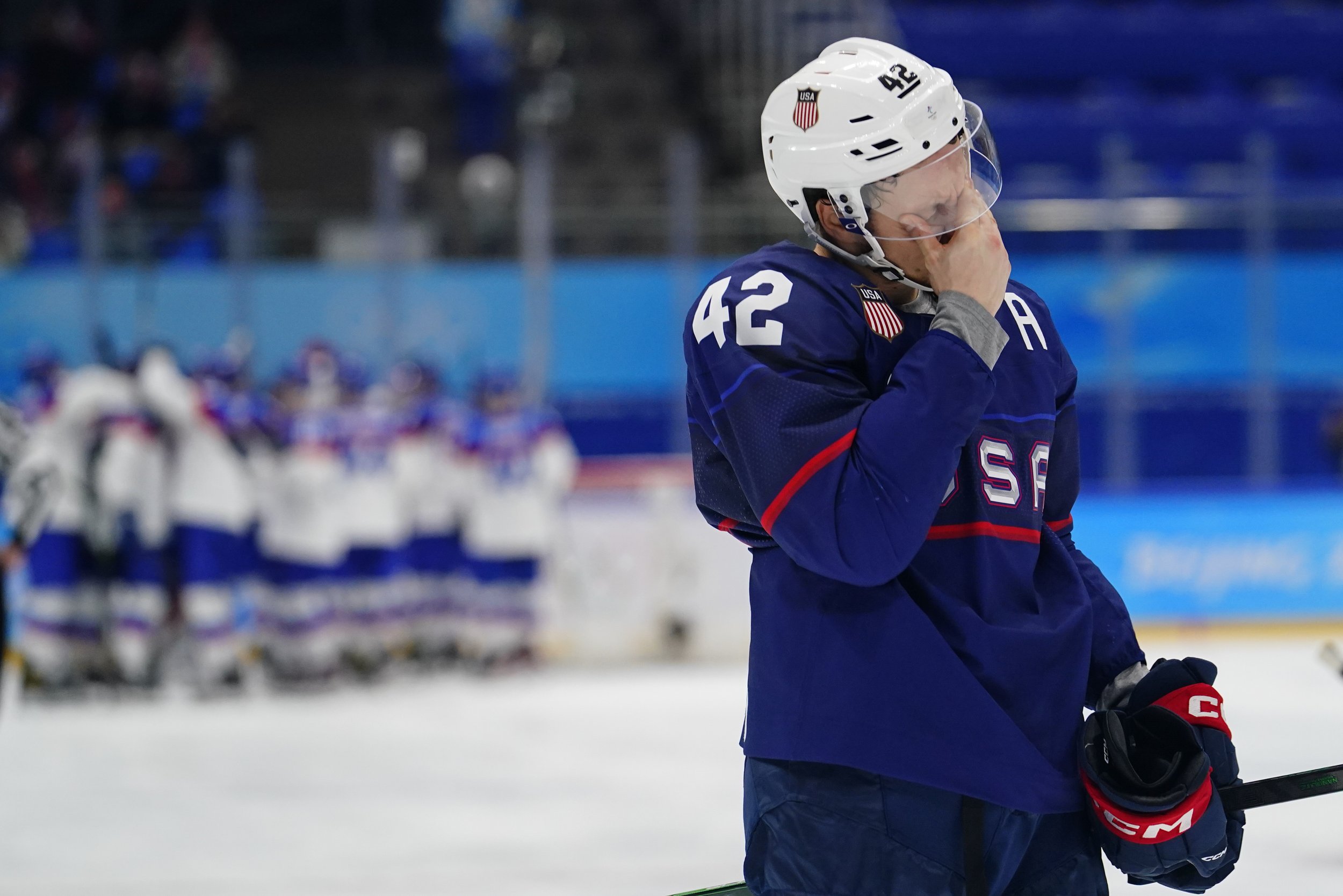  United States' Aaron Ness (42) leaves the ice as Slovakia players celebrate behind him after a men's quarterfinal hockey game at the 2022 Winter Olympics, Wednesday, Feb. 16, 2022, in Beijing. Slovakia won 3-2 in a shoot-out. (AP Photo/Matt Slocum) 