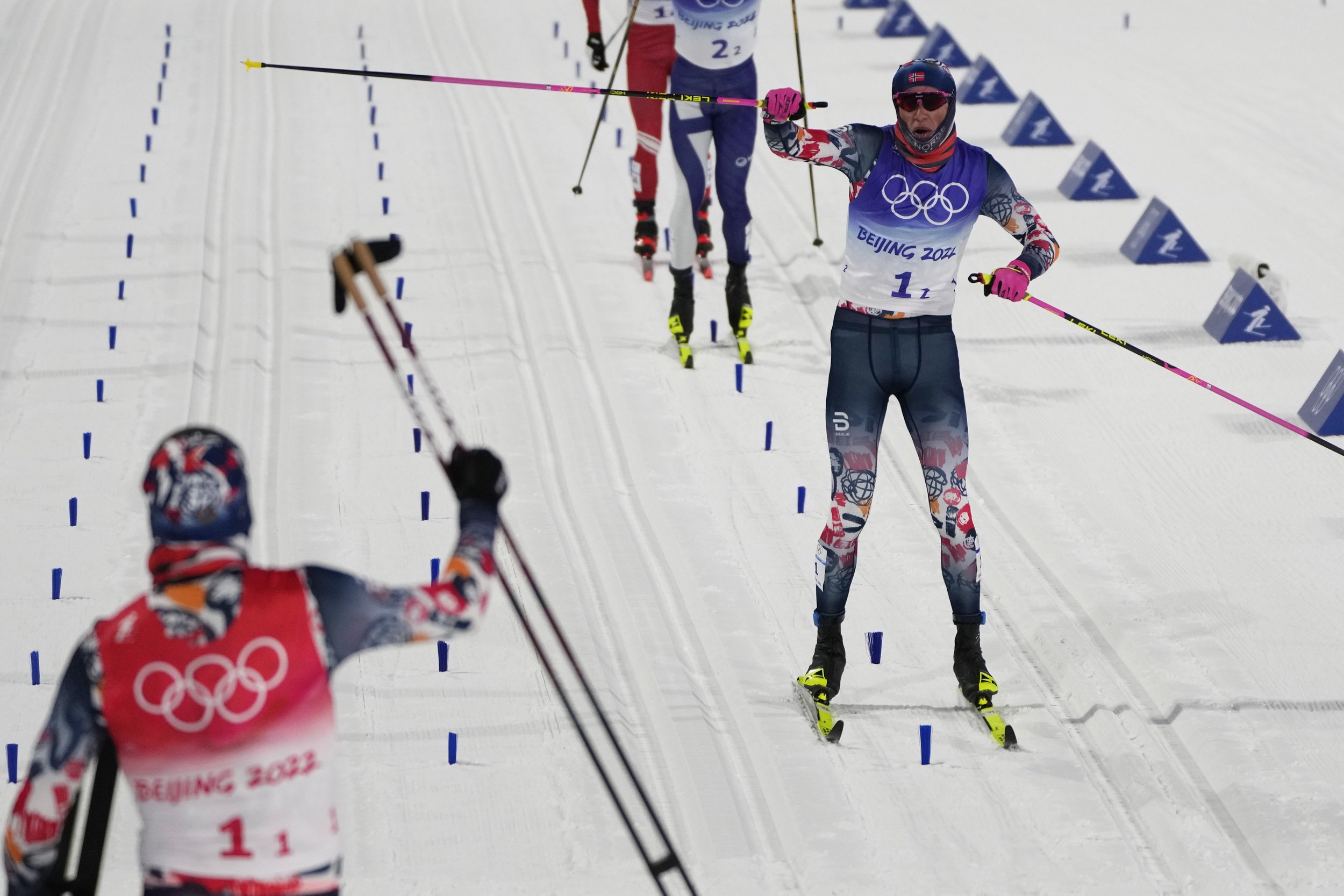  Johannes Hoesflot Klaebo, of Norway, right, celebrates as he nears the finish with Erik Valnes, of Norway, left, during the men's team sprint classic cross-country skiing competition at the 2022 Winter Olympics, Wednesday, Feb. 16, 2022, in Zhangjia