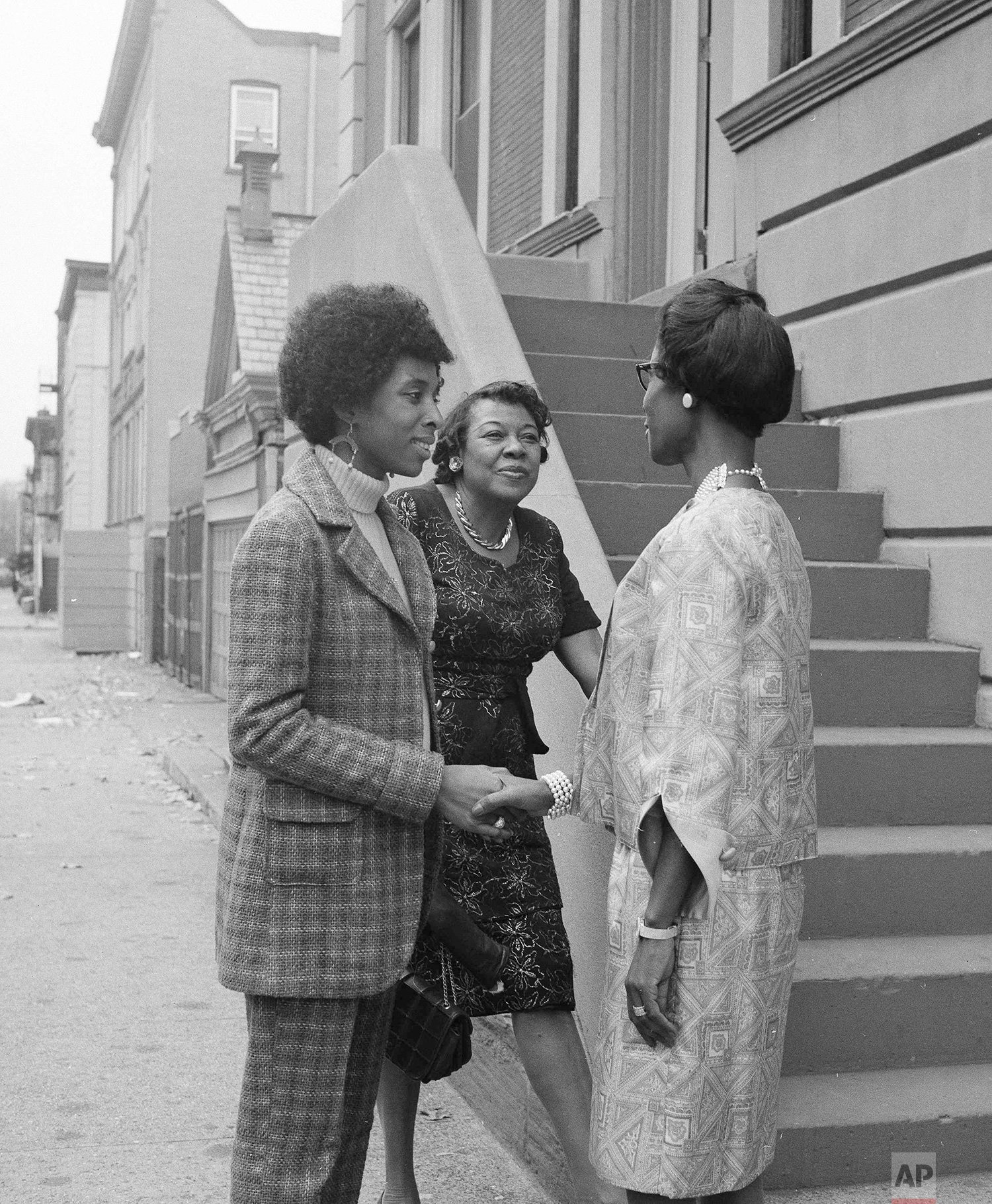  Mrs. Shirley Chisholm of 1165 Sterling Place in Brooklyn,  the first Black Congresswoman in Washington.   Shown in a photo on Nov. 6, 1968, while talking on the street to  Mrs. Elsa Bennet, left, Mrs. Sallie Owens  (AP Photo) 