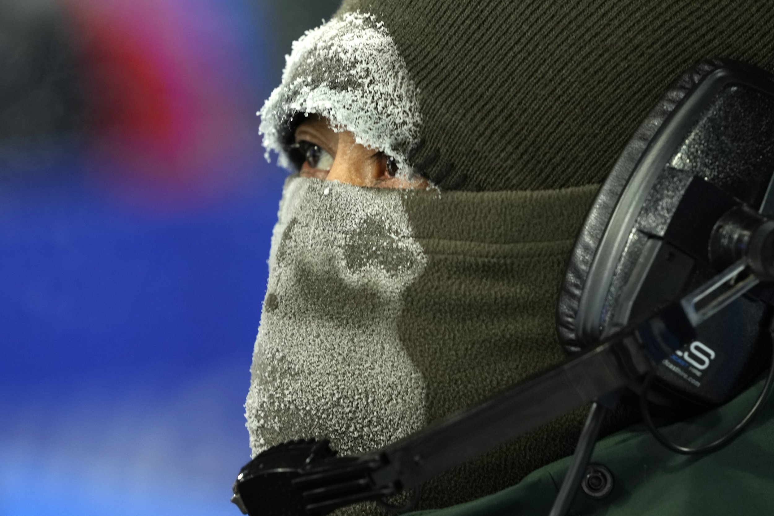  Frost covers the face mask of a broadcast camera operator during the men's aerials finals at the 2022 Winter Olympics, Wednesday, Feb. 16, 2022, in Zhangjiakou, China. (AP Photo/Francisco Seco) 