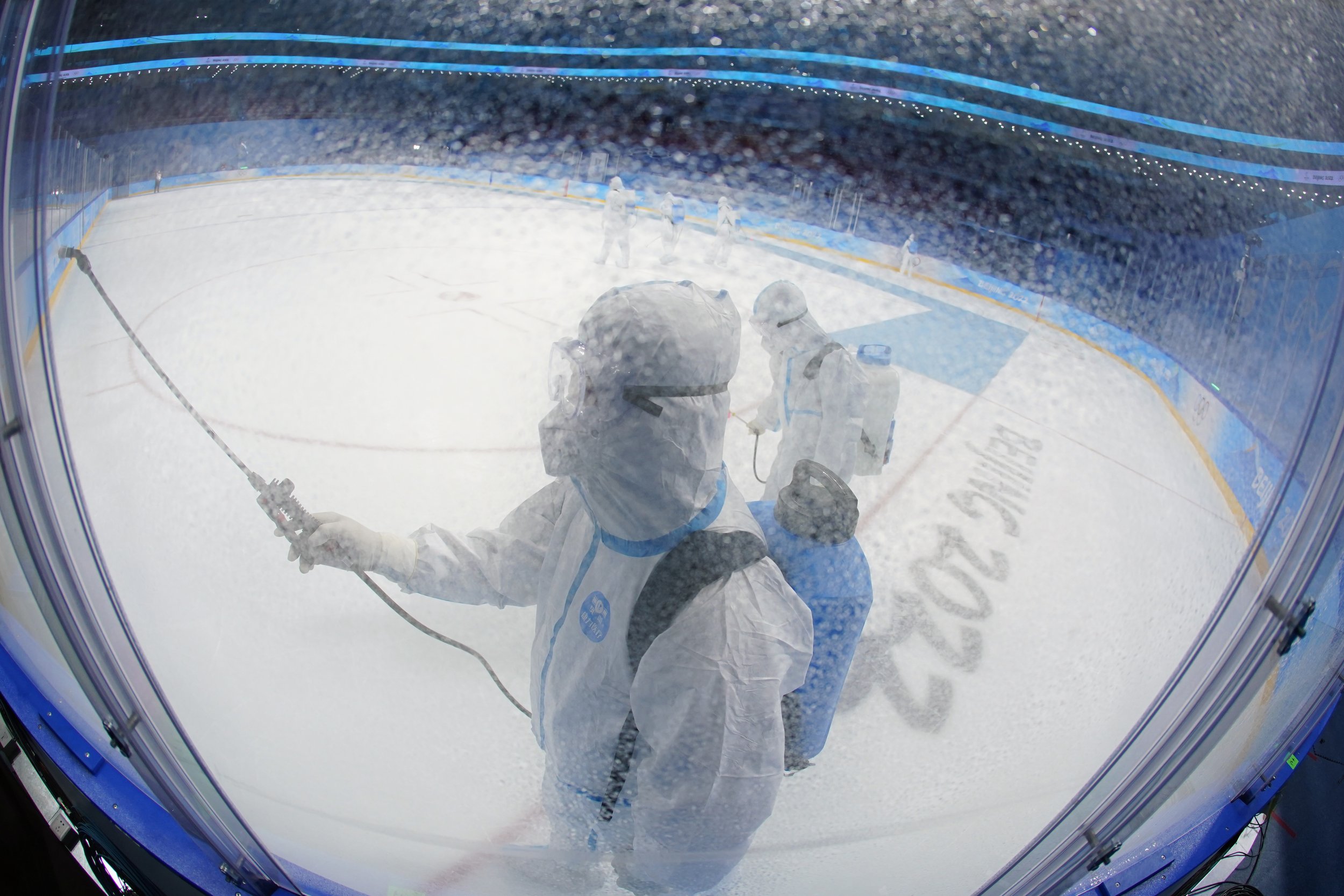  A worker disinfects the ice rink after the women's gold medal hockey game at the 2022 Winter Olympics, Thursday, Feb. 17, 2022, in Beijing. (AP Photo/Matt Slocum) 