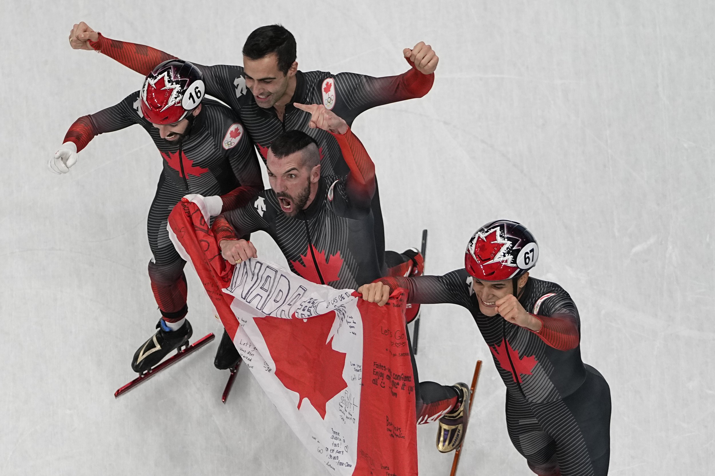  Members of team Canada celebrate after winning the gold medal in the men's 5000-meter relay finals during the short track speedskating competition at the 2022 Winter Olympics, Wednesday, Feb. 16, 2022, in Beijing. (AP Photo/Jeff Roberson) 