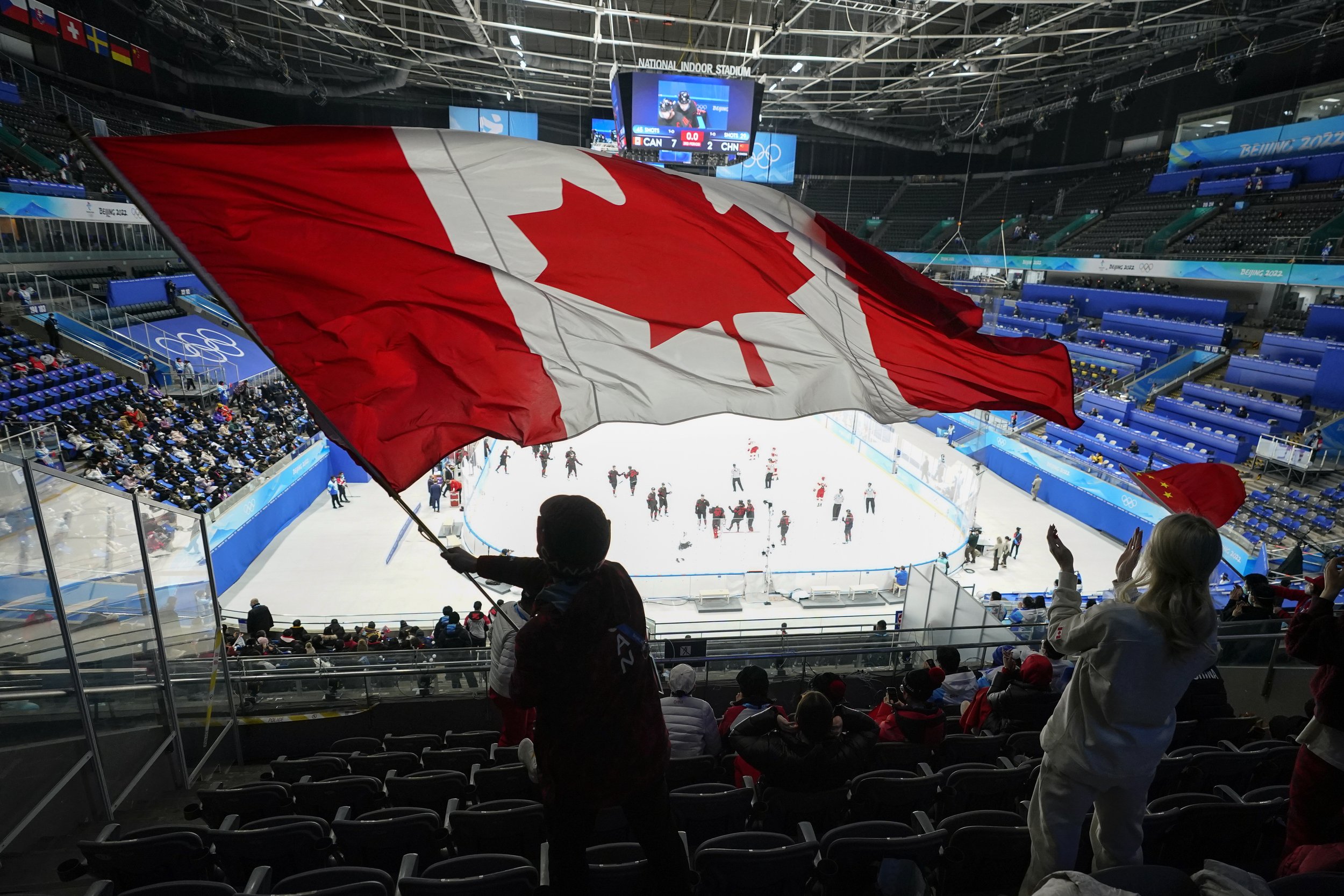  A fan waves a Canadian flag following a men's qualification round hockey game between Canada and China at the 2022 Winter Olympics, Tuesday, Feb. 15, 2022, in Beijing. Canada won 7-2. (AP Photo/Mark Humphrey) 