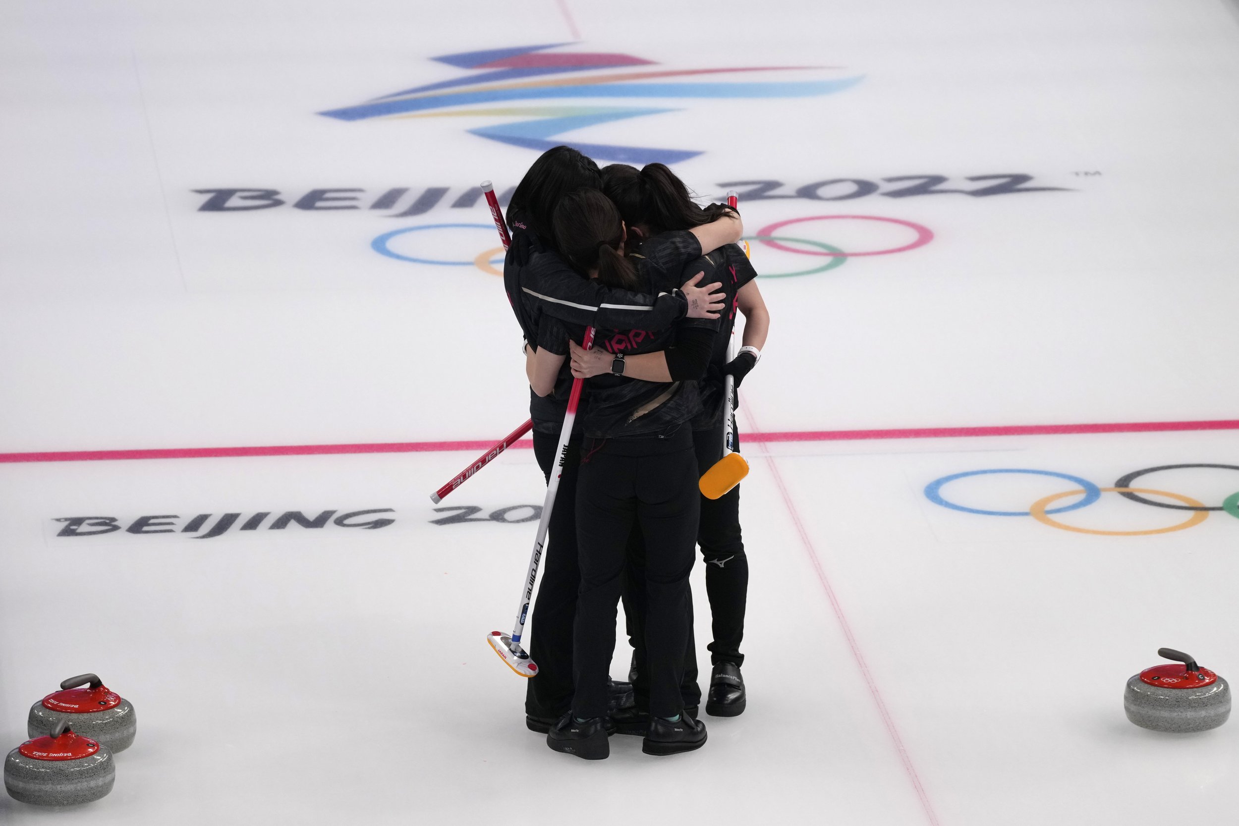  Japan's athletes celebrate after winning the women's curling semifinal match between Japan and Switzerland at the Beijing Winter Olympics Friday, Feb. 18, 2022, in Beijing. (AP Photo/Nariman El-Mofty) 