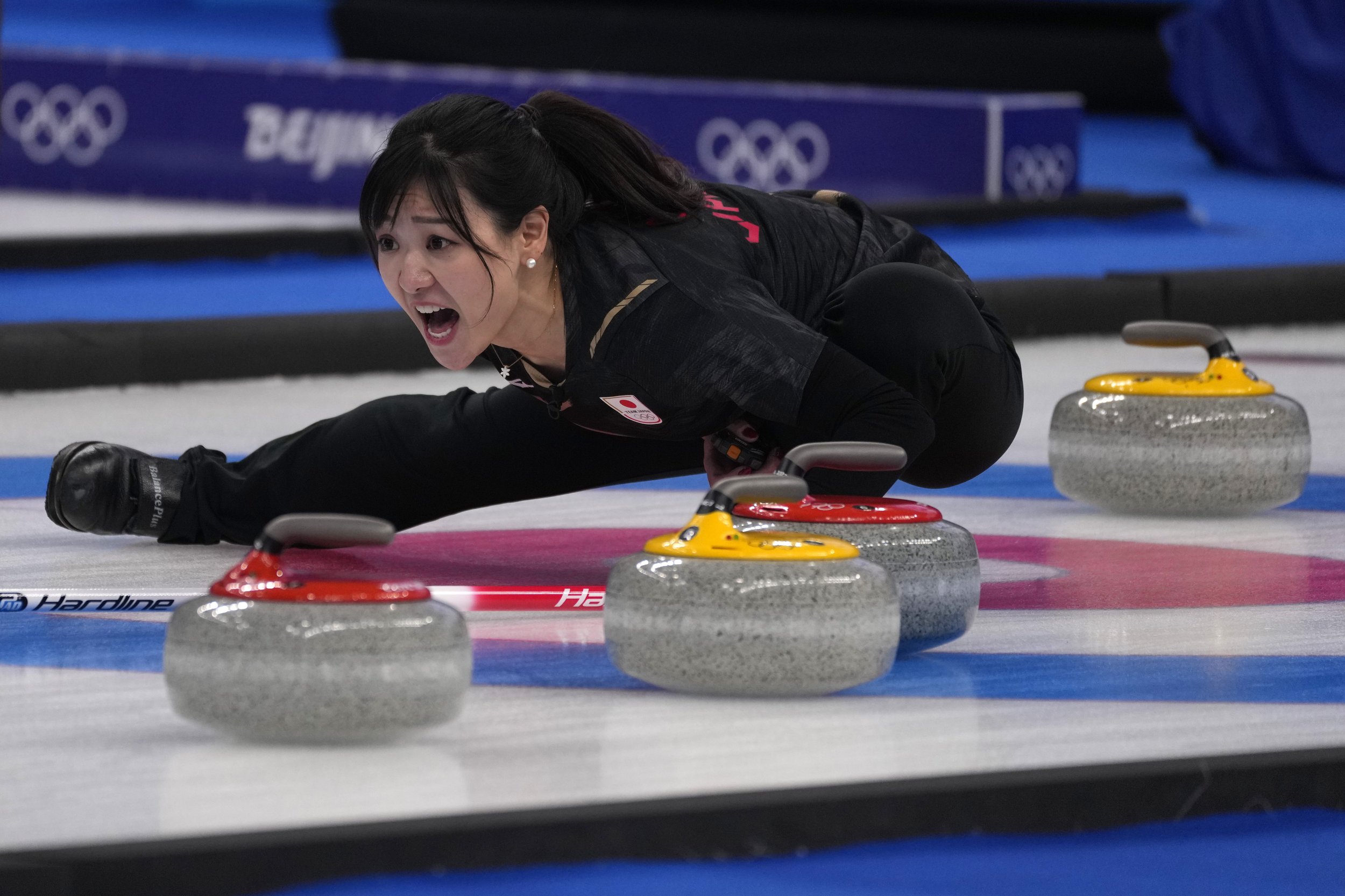  Japan's Chinami Yoshida shouts instructions to teammates during a women's curling semifinal match between Japan and Switzerland at the Beijing Winter Olympics Friday, Feb. 18, 2022, in Beijing. (AP Photo/Nariman El-Mofty) 
