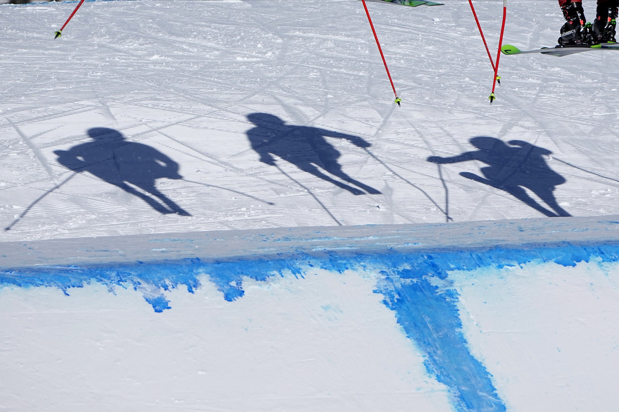  The shadows of the skiers cast on the course during the men's cross finals at the 2022 Winter Olympics, Friday, Feb. 18, 2022, in Zhangjiakou, China. (AP Photo/Gregory Bull) 