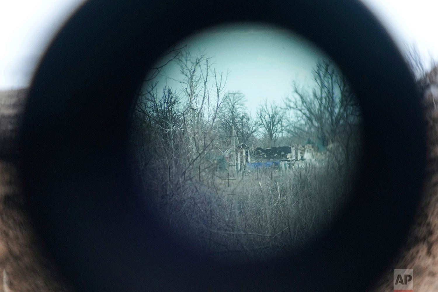  The gray area is visible through the periscope on a Ukrainian Army position at the line of separation between Ukraine-held territory and rebel-held territory near Zolote, Ukraine, late Saturday, Feb. 19, 2022. (AP Photo/Evgeniy Maloletka) 