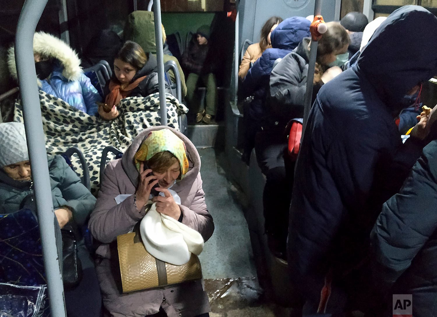  People sit inside a bus waiting to be evacuates to Russia amid crisis in Donetsk, the territory controlled by pro-Russian militants, eastern Ukraine, Friday, Feb. 18, 2022.  (AP Photo/Alexei Alexandrov) 