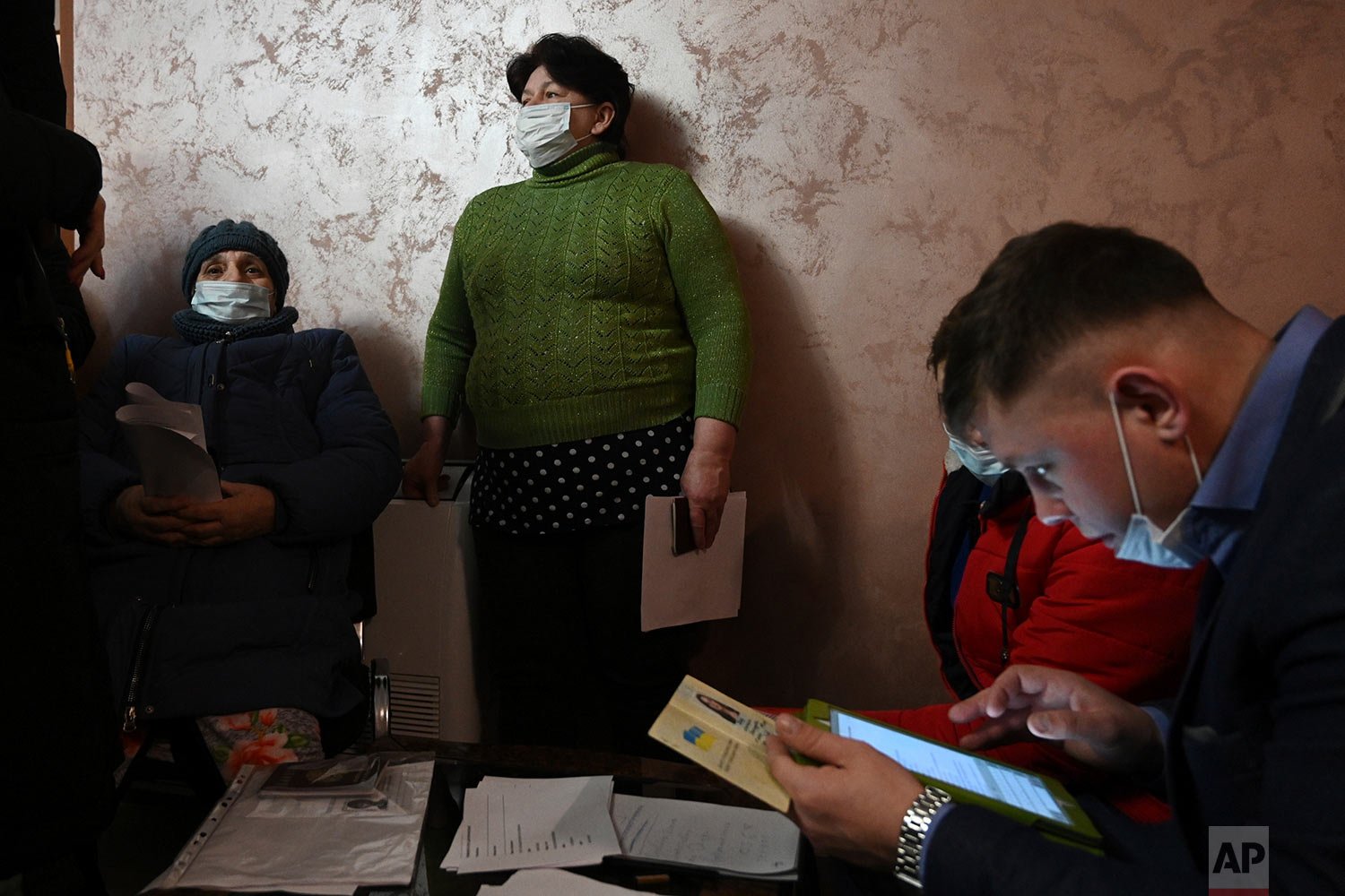  People from Donetsk, the territory controlled by a pro-Russia separatist government in eastern Ukraine, gather to fill in documents after evacuating in the Rostov-on-Don region, near the border with Ukraine, Russia, Sunday, Feb. 20, 2022. (AP Photo)