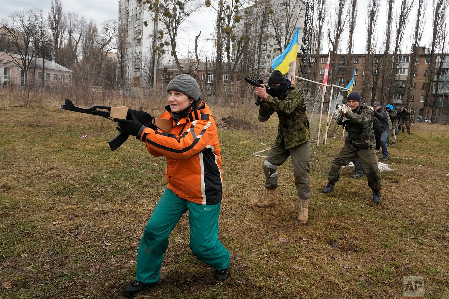  Civilians train with members of the Georgian Legion, a paramilitary unit formed mainly by ethnic Georgian volunteers to fight against Russian forces in Ukraine in 2014, in Kyiv, Ukraine, Saturday, Feb. 19, 2022. (AP Photo/Efrem Lukatsky) 